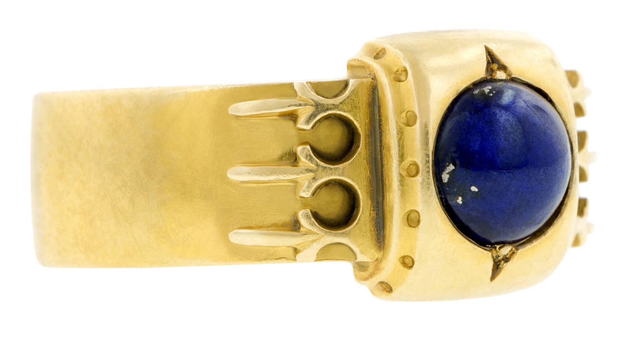 Victorian lapis mourning ring centering a cabochon lapis measuring app.6.2mm in a square mount with detailed shoulders and locket back, fashioned in 18k. Hand engraved with 