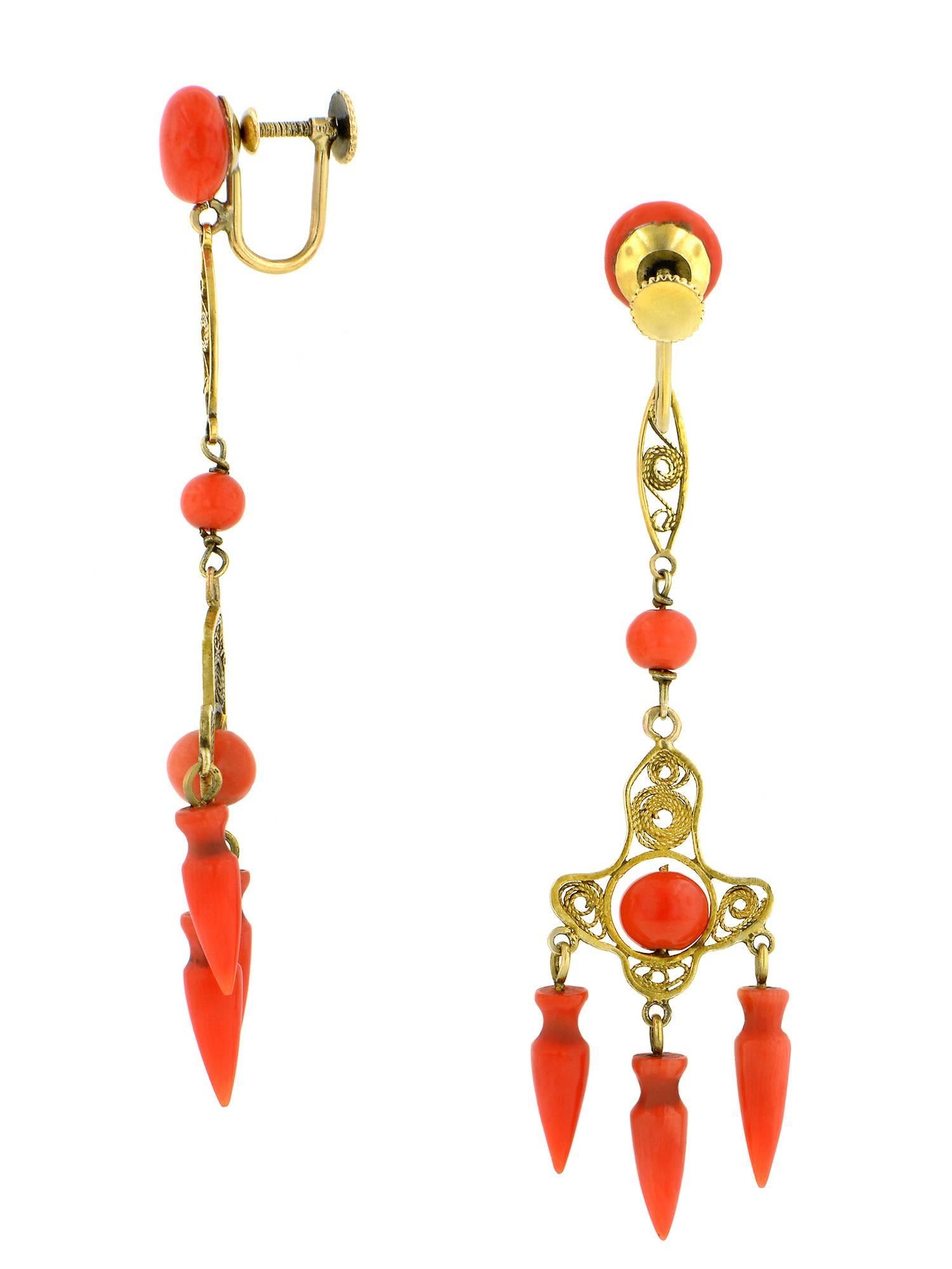 Victorian coral filigree earrings chandelier, non-pierced screwback earrings, measure 2.75 inches long, featuring twist filigree open wire work placed with threaded off-round orange-red coral beads along with coral amphora drops, set in a girandole