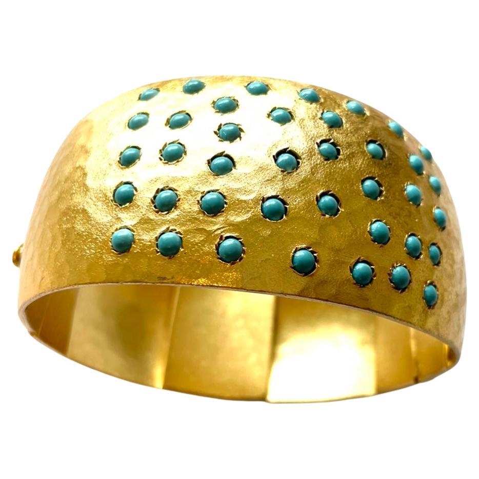 Description
This gorgeous and eye-catching cuff is sure to make a captivating statement with any of your outfits. The beautifully hand-hammered gold color of the matte finished vermeil is strikingly contrasted with the vibrant blue turquoise stones