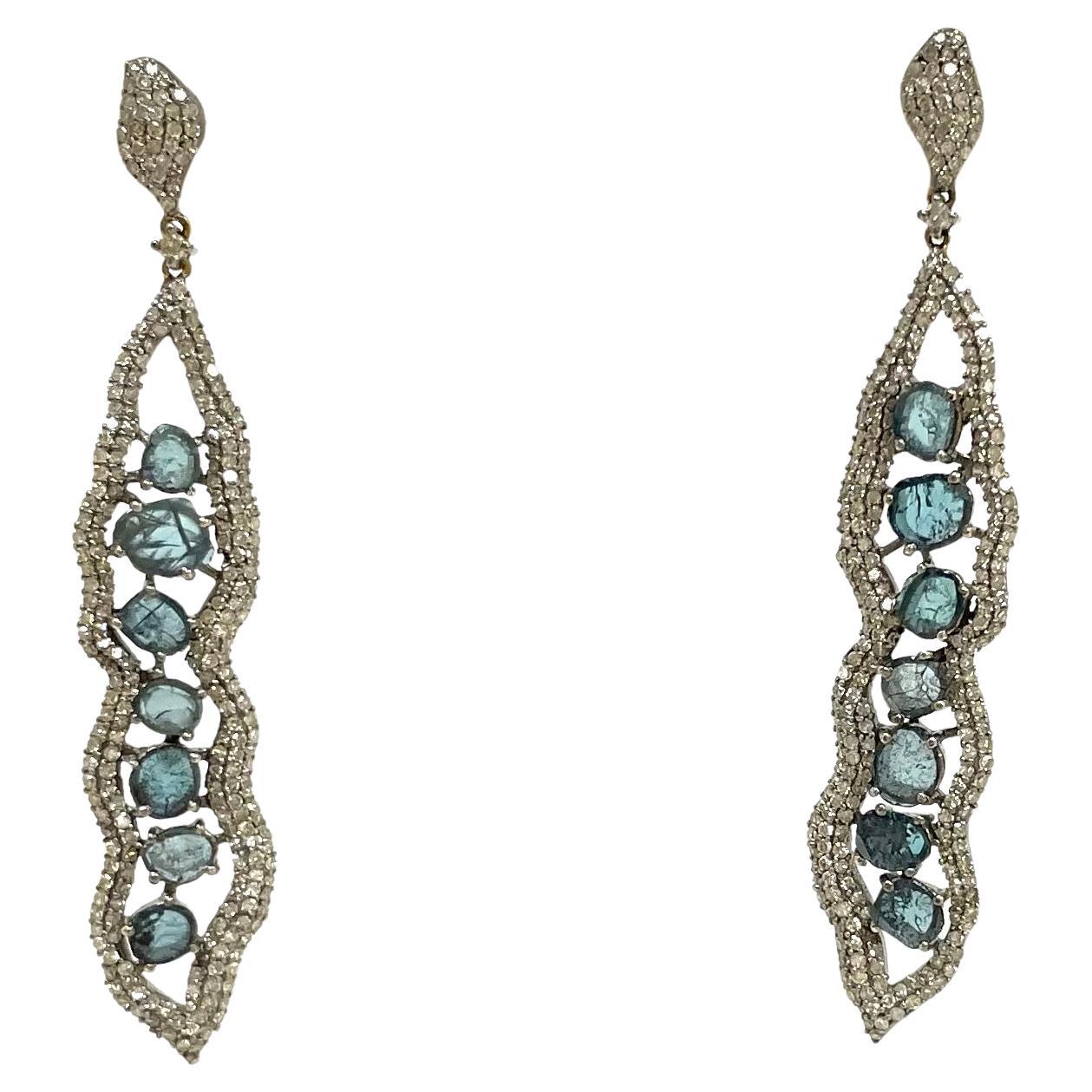 Description
Gorgeous, edgy yet feminine, blue diamond slices, framed in an artistic setting of pave diamonds.

Item # E3273

Materials and Weight
Blue diamonds, 14 pieces, slices
Pave diamonds
Rhodium sterling silver
14k gold posts and jumbo