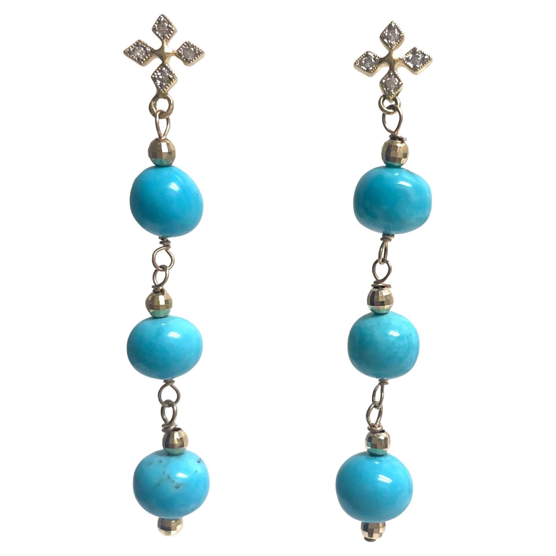 Description
Beautiful, vibrant Sleeping Beauty turquoise individually wire wrapped suspended from pave diamond ear posts and accented with small yellow gold faceted balls to create a harmonious feminine style. 
Item # E3400
Pair with matching