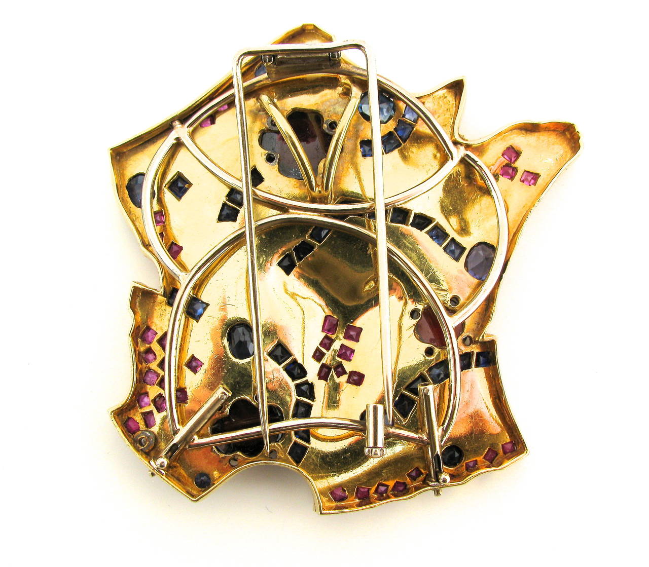 A Dramatic gold and gemstone pendant/ brooch. The 2 5/8