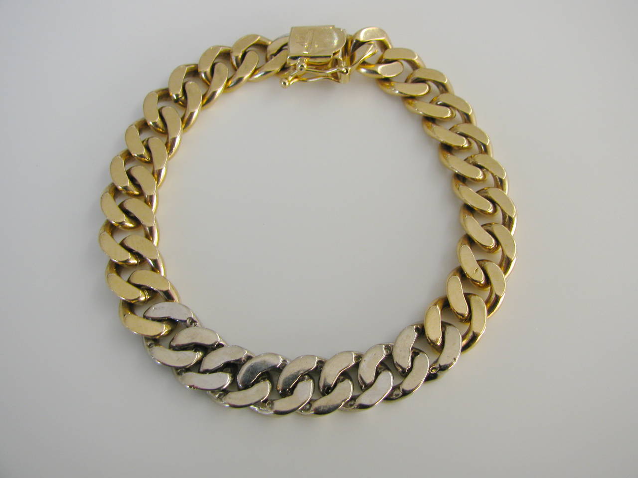 A Handsome yellow gold bracelet by Tiffany and Co. The  7