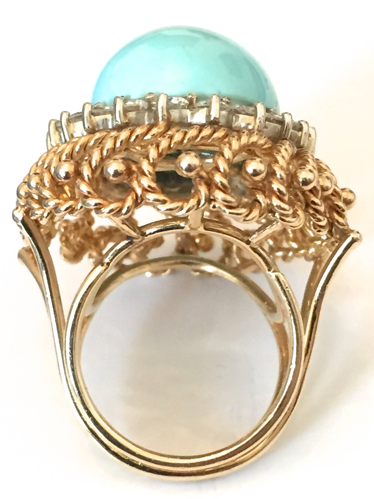 A Pretty turquoise and diamond cocktail ring. The robin's egg blue cabochon turquoise stone is surrounded by approximately 2.00ct of round white diamonds in an 1 1/4 