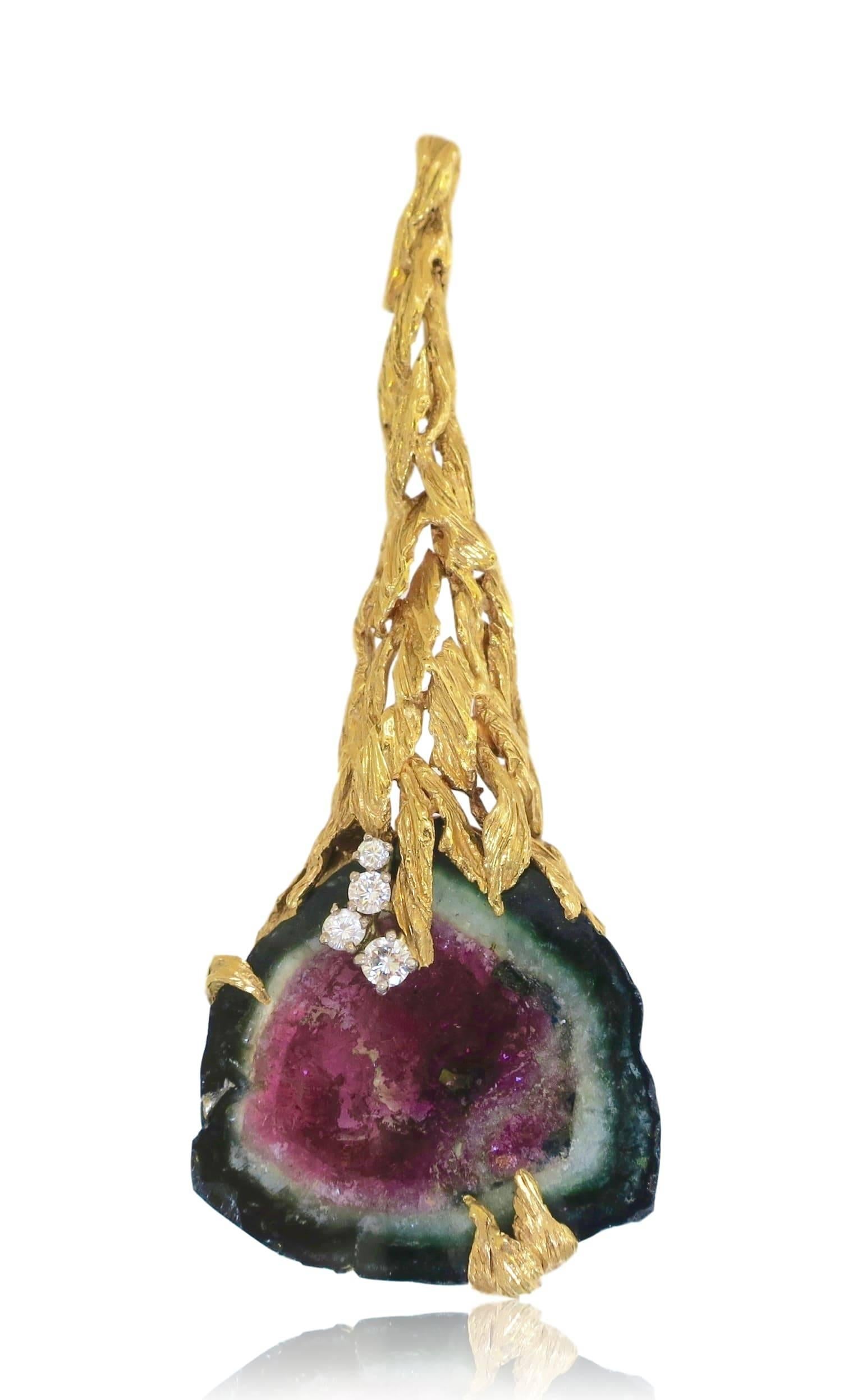 Sculptural pendant necklace by Swiss designer Gilbert Albert. The 3"long pendant with textured gold in the form of stylized leaves holds a dramatically large slice of watermelon tourmaline. Accented with diamond "dew drops" .
A smart