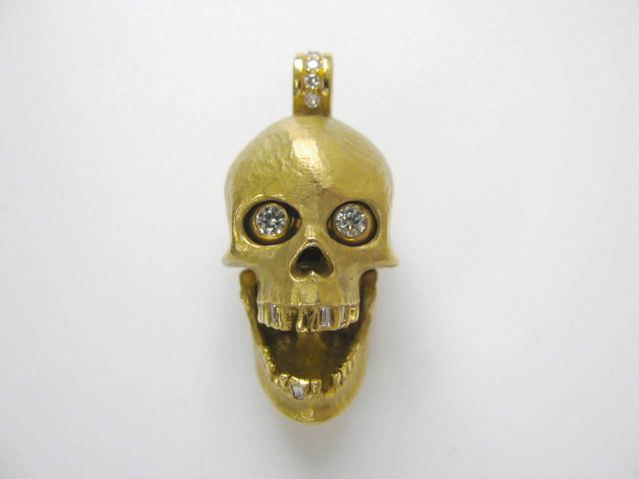 Modern An Articulated Gold and Diamond Skull Pendant
