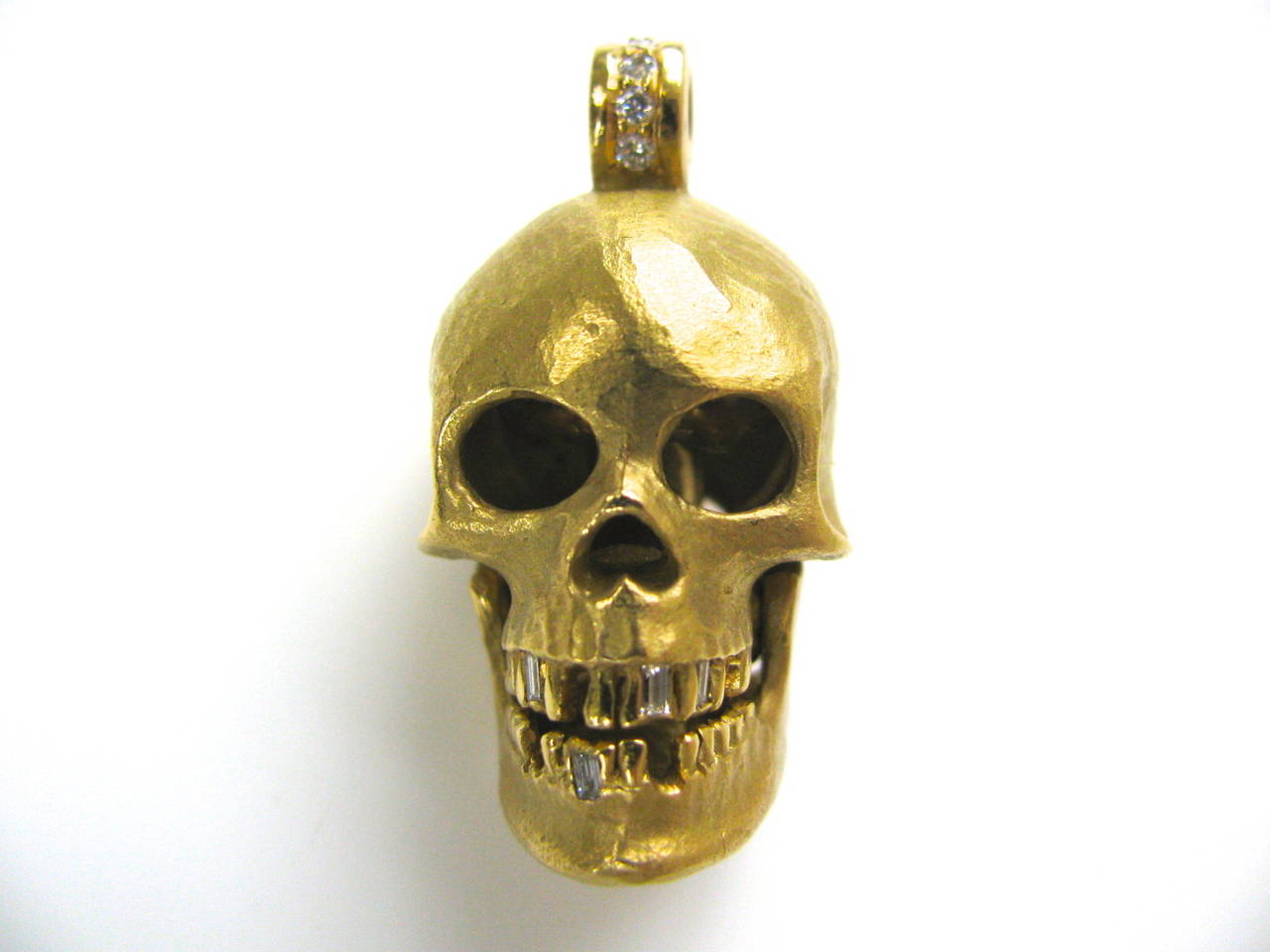 A Wicked Gold and Diamond Skull Pendant. The 1 1/2