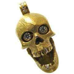 An Articulated Gold and Diamond Skull Pendant