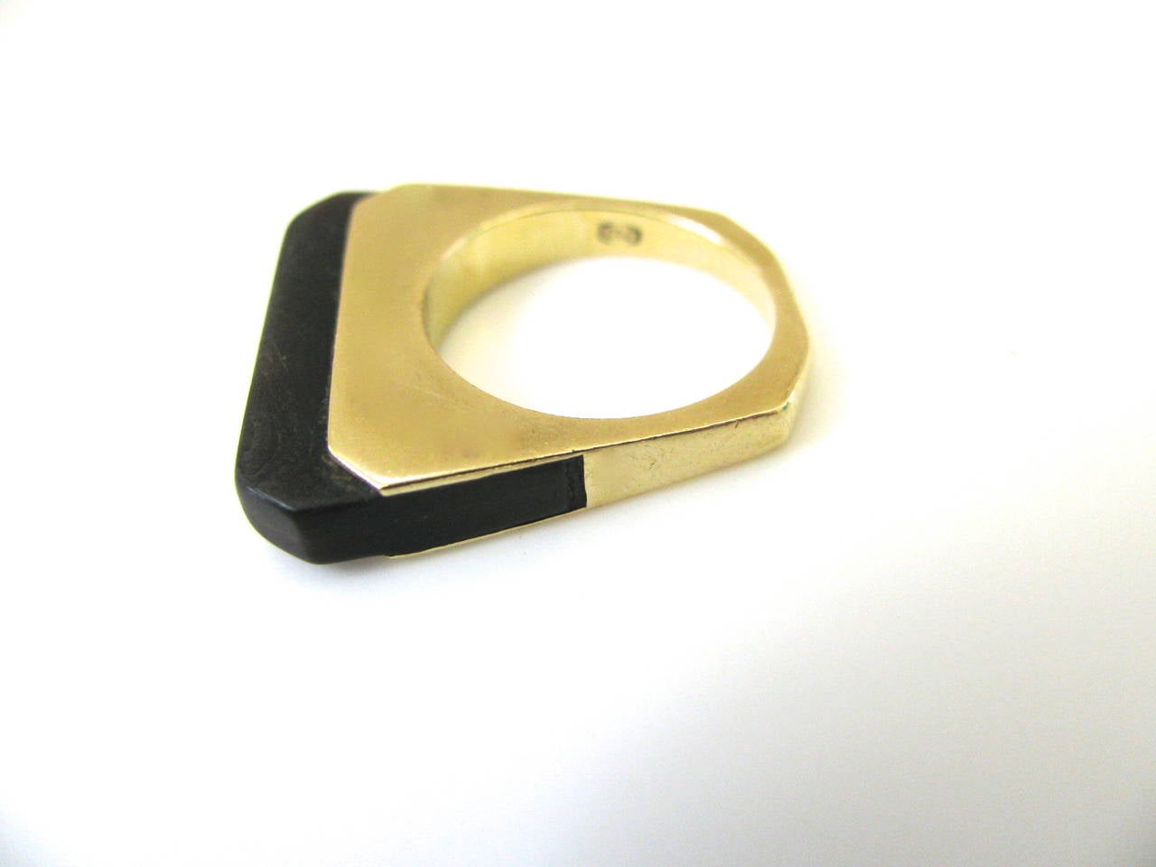 A Stylish Wood and Gold Ring. The 18k Yellow gold trapezoidal band inset with carved wood. The Minimalist design so 70's. A Nice everyday ring. Great for stacking. Chic and comfortable. European. Size 5 3/4.