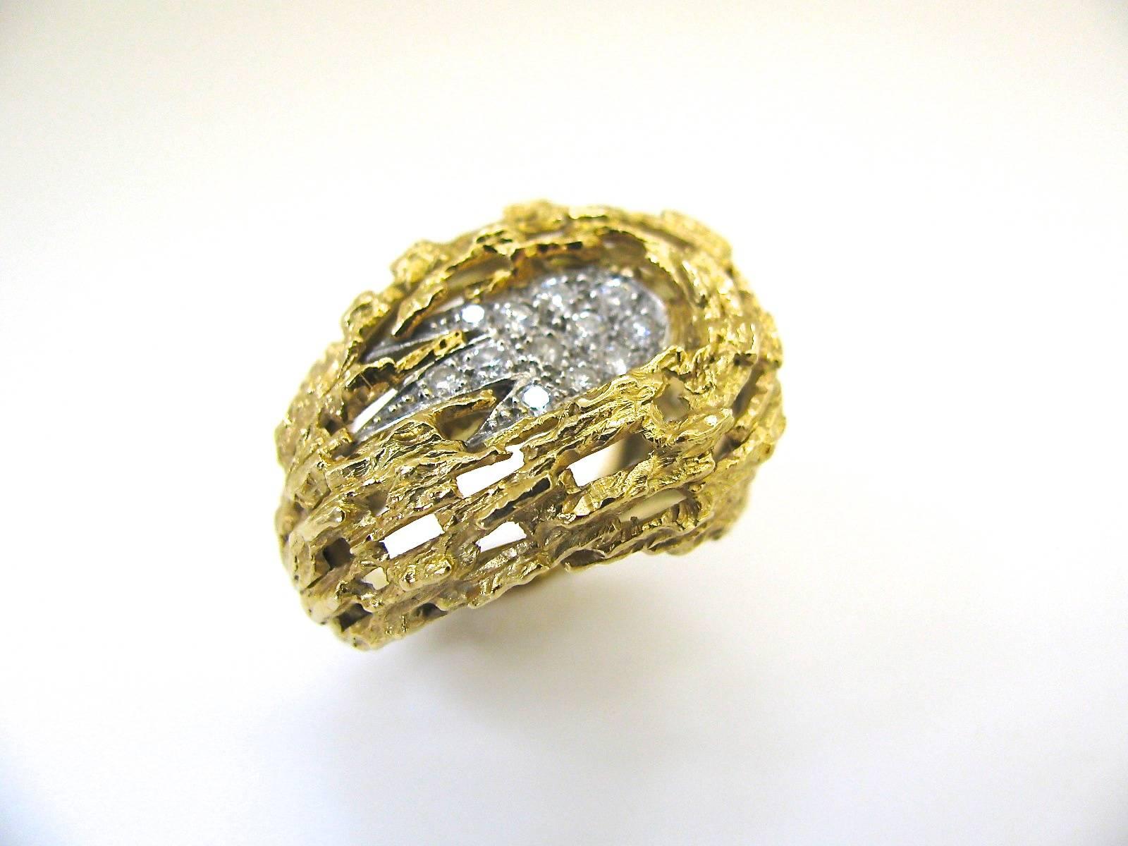 A stylish ring by Andrew Grima. The 18k yellow gold freeform ring with twelve pave set white diamonds. ( approximately .50cts) A great day to night ring. Just understated enough to wear with clients, but showy enuf for dinner. A wonderful go-to