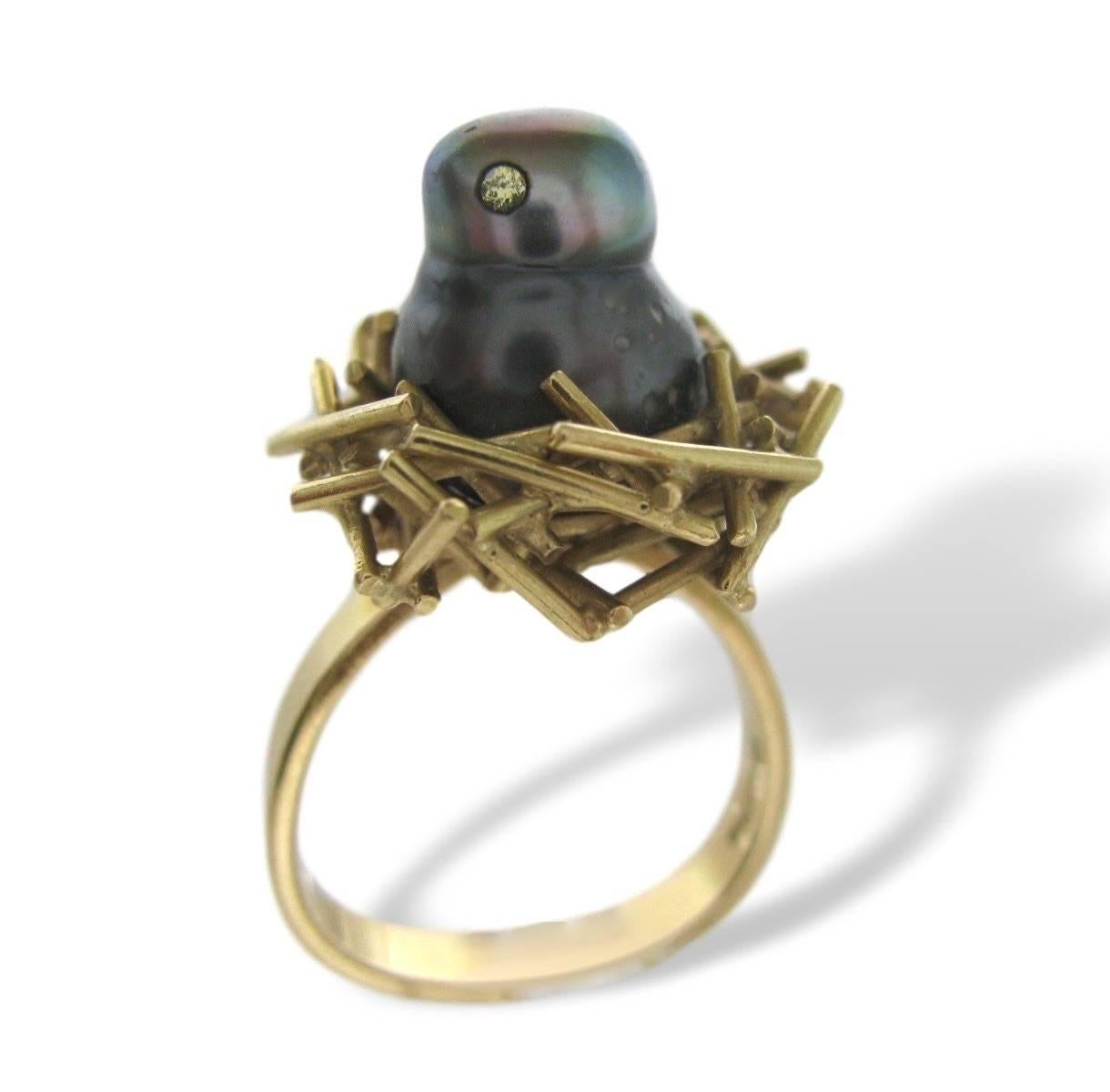 Tahitian pearl chick ring by Andrew Grima. The 18k mount in the shape of a stylized nest in which a Chick -shaped black-grey pearl with light gold diamond eyes happily nests. A cute and sentimental piece of Grima Jewellery. Know for his love of