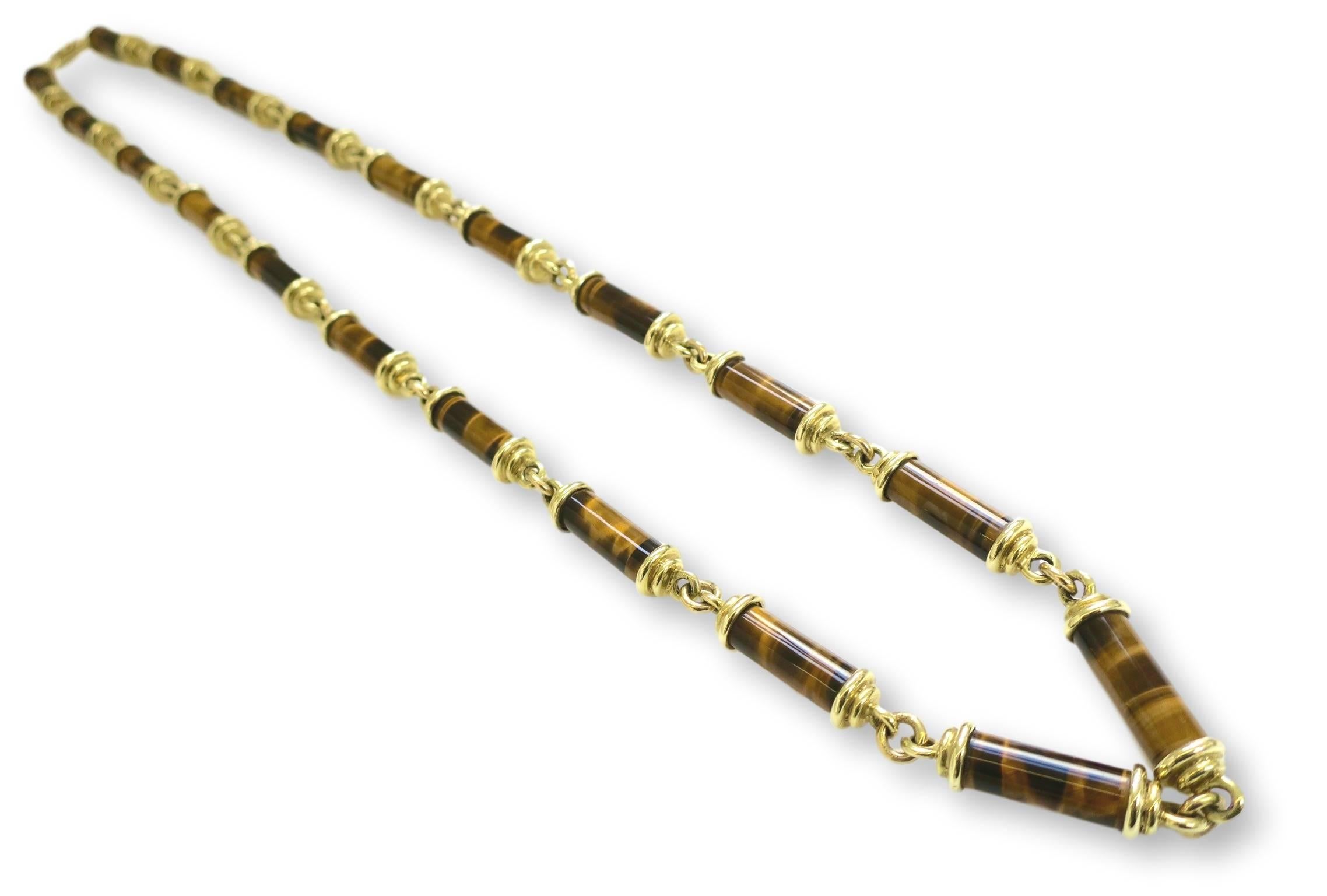 Substantial gold and tigerseye chain necklace. The 27.5" necklace with columnar-shaped polished tigerseye and 14k yellow gold caps and links. 
Its works well on its own but also could easily sport 
a medallion if desired. The warm and lustrous