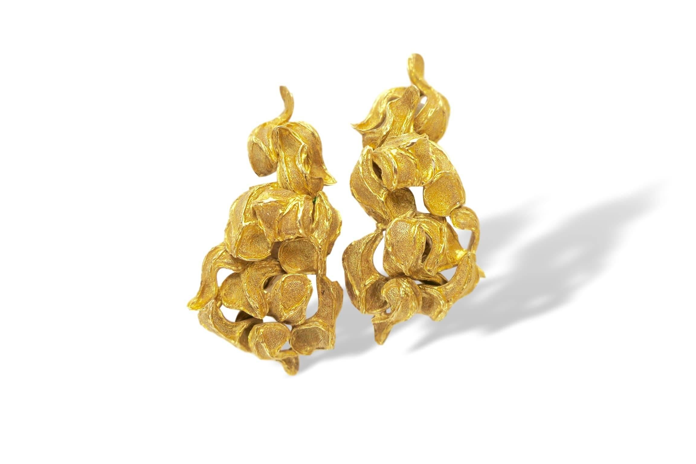 Textured 18k yellow gold earclips. The 2" 18k yellow gold foliate earrings with textured matte finished leaves. These rich colored yellow gold earrings, designed for the left ant right ear, sit comfortably on the lobe and hug the shape of the