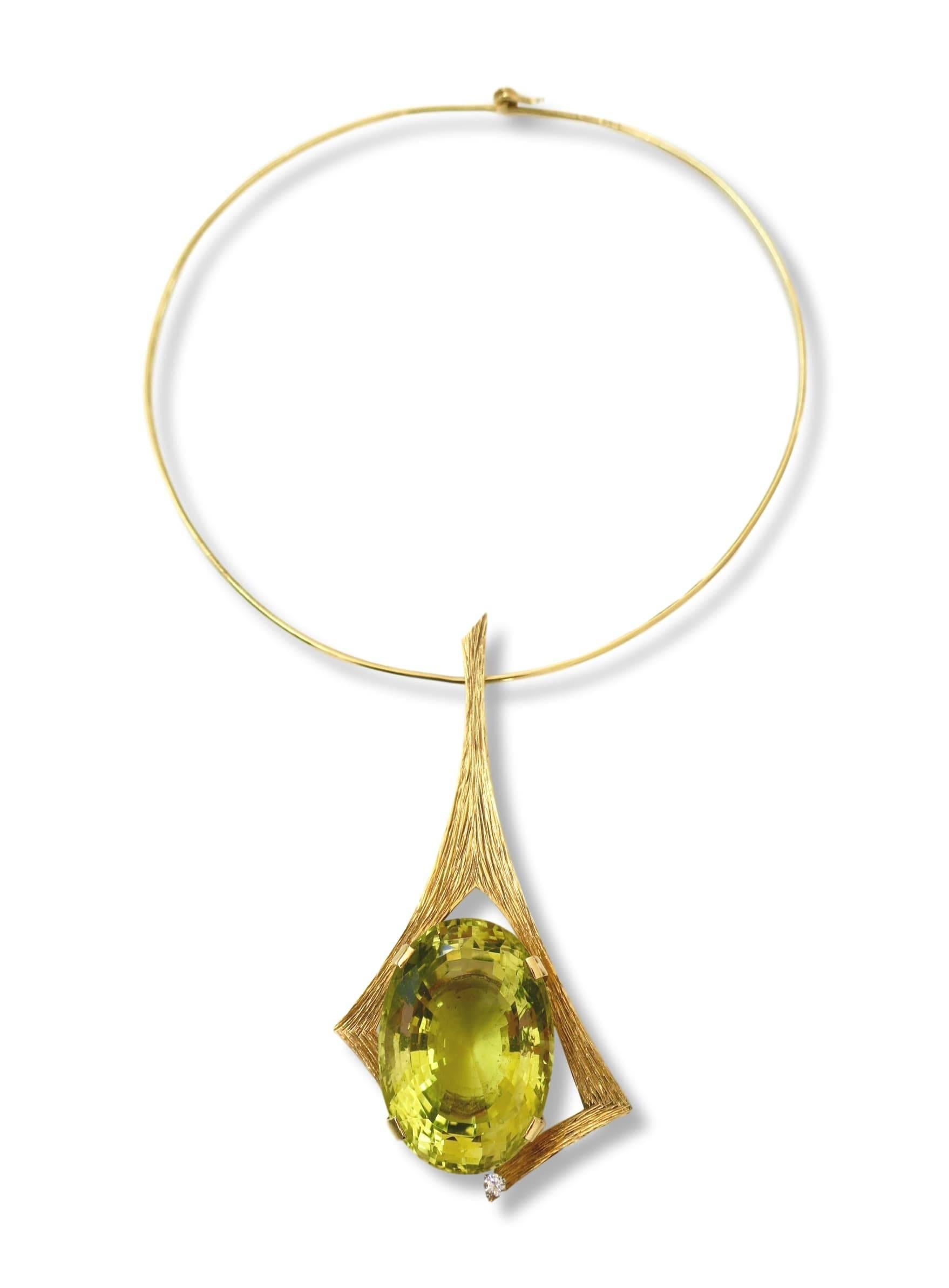 Modernist 172 carat bright yellow lemon quartz pendant necklace by British designer Andrew Grima. The 18k 3 3/4 x 1 6/8 engraved yellow gold mount with an impressive bright yellow mixed-cut citrine enhanced by a small round white diamond, suspended