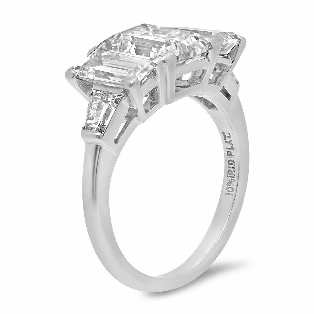 Stylish midcentury platinum ring centered with a GIA certified 2.24 carat step cut diamond with G color, VS2 clarity and Non Florescence, flanked by two matching rectangular step cut diamonds on each side, both GIA certified .83 carat, F color, VVS1