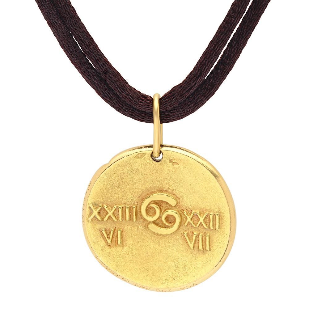Van Cleef & Arpels Cancer Zodiac Medallion in 18K Yellow Gold suspended on 18 inches Silk Cord . The Medallion is over 1inch in diameter 