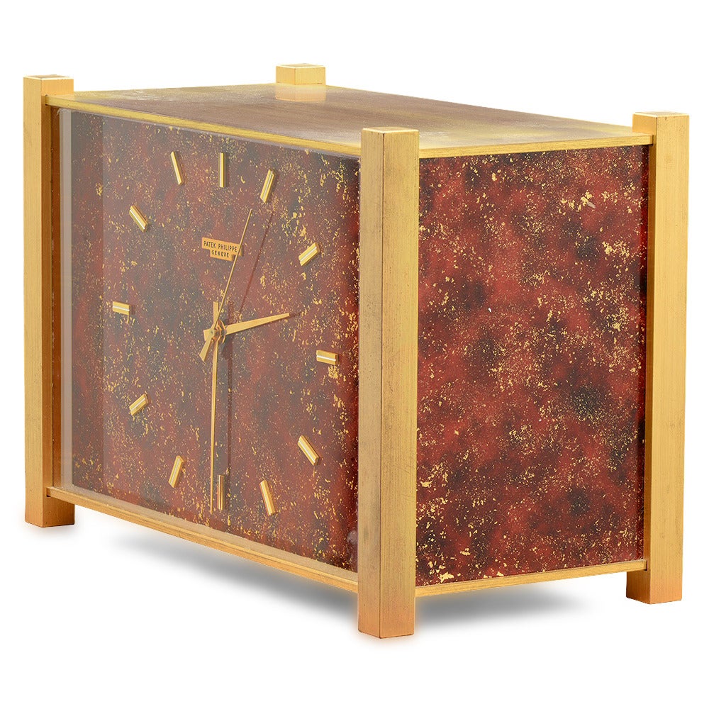 A very rare, unusual and attractive reddish lacquered electronic quartz Patek Philippe desk clock with sweep center seconds.
Signed Patek Philippe Geneve  
210 mm length & 140 mm high