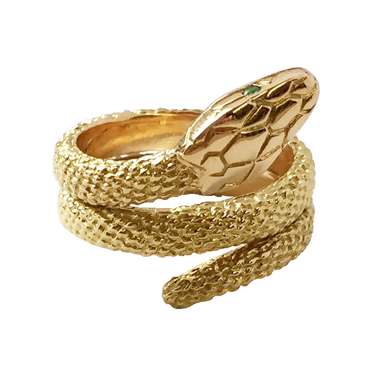 This golden, emerald-eyed serpent by Cartier coils thrice around your finger. Crafted in 18 karat yellow gold. Stamped CARTIER, 124065, 750 for K18. This ring cannot be sized.