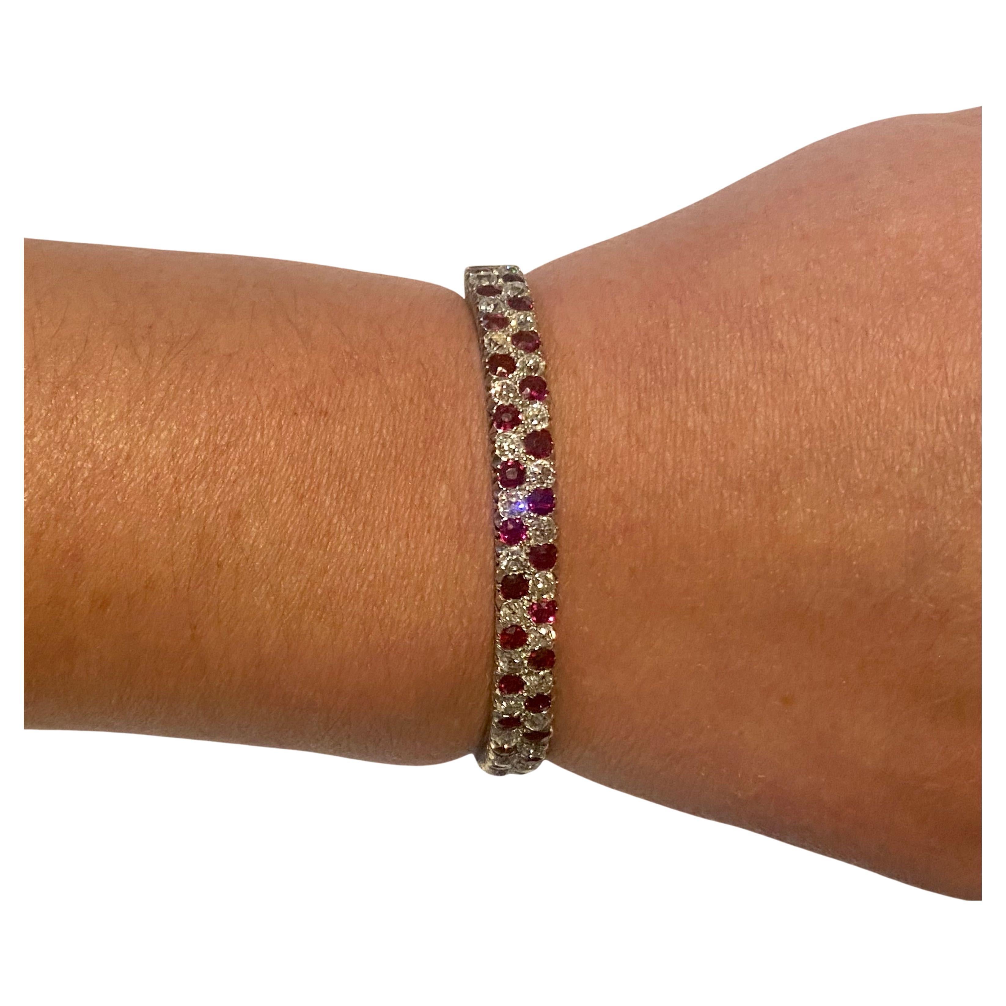 A High quality 18k White gold diamond and ruby hinged Bangle, the front with two rows, each channel set with fifteen alternate Old European cut diamonds and rubies,. The bright red 3mm Rubies assessed as approximately 0.15 carat each,  totalling