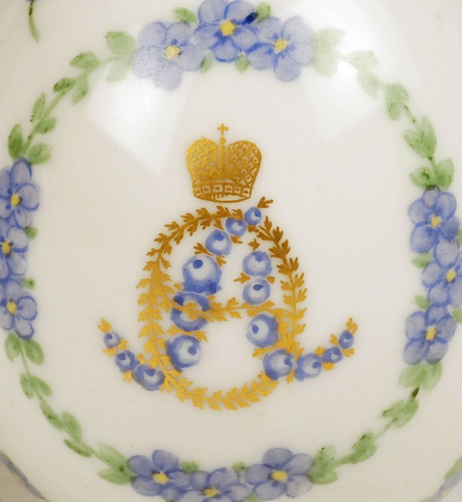 A Russian porcelain Easter egg, Imperial Porcelain Factory, St Petersburg, circa 1894-1915. Centered with the cypher of Empress Alexandra formed as floriated initials of blue rosebuds and gilt laurel, surmounted by a gilt Imperial crown, the initial