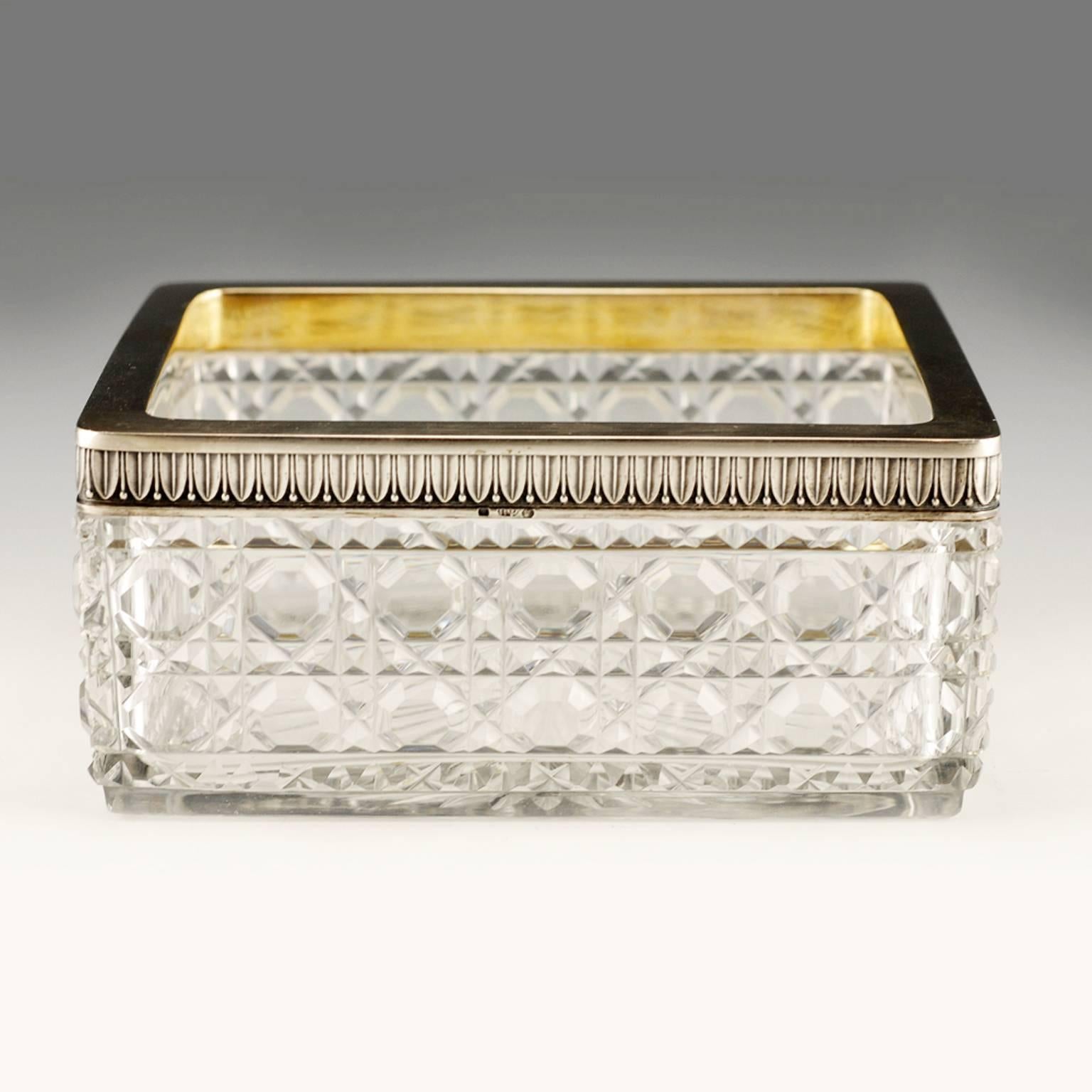 A Russian silver-mounted rectangular cut lead glass serving dish, Petr Fariseev, Moscow, circa 1908-1917. In Neoclassical taste, the rectangular glass dish, almost cetainly from the Bakhmetev Glassworks, cut in a combination hobnail-cane pattern,