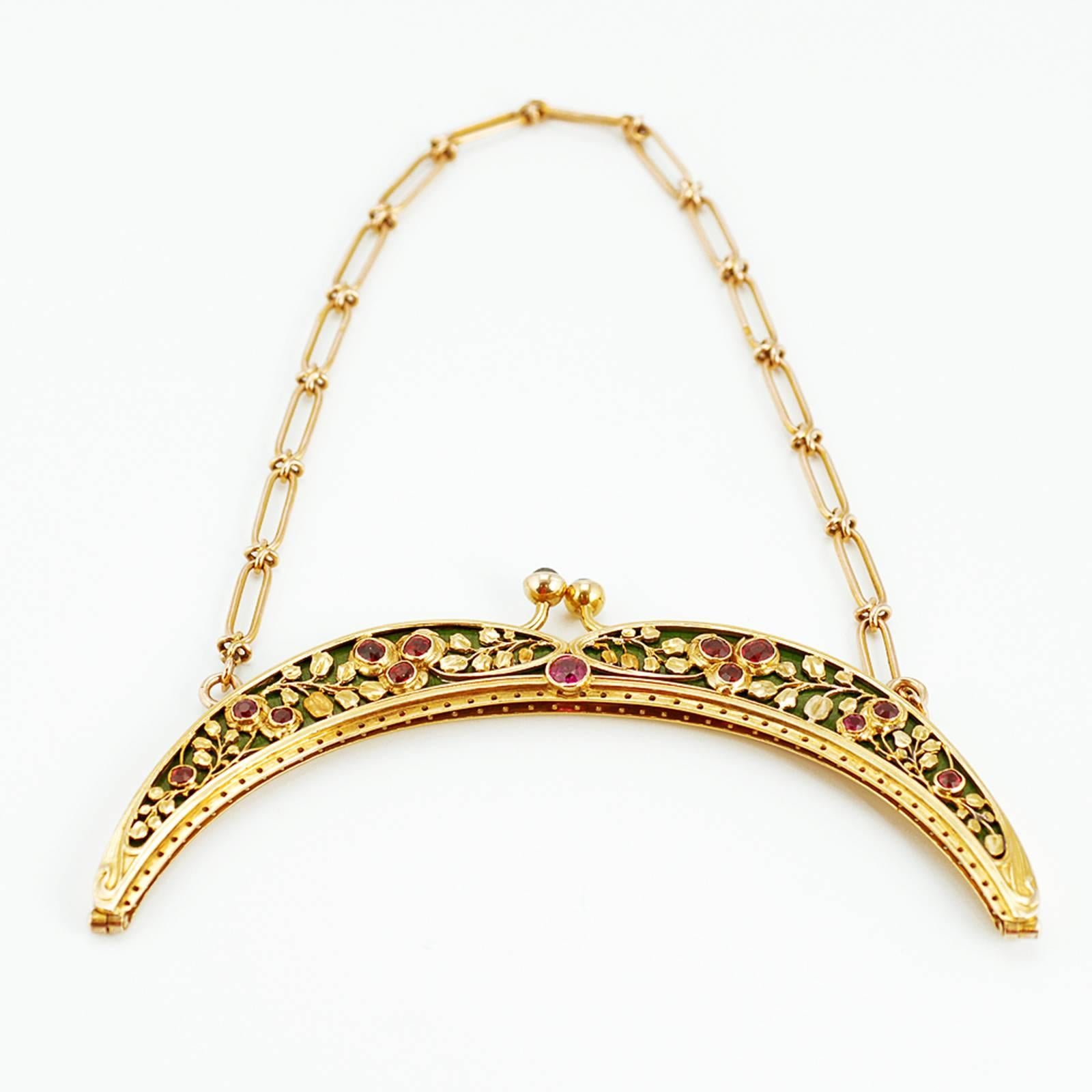 A Russian Art Nouveau jeweled varicolored gold and guilloché enamel purse frame for an evening bag, struck with Cyrillic maker’s mark VG for Vasilii Grishin, Moscow, circa 1899-1908. The arch-shaped frame with gold casework chased as a flowering