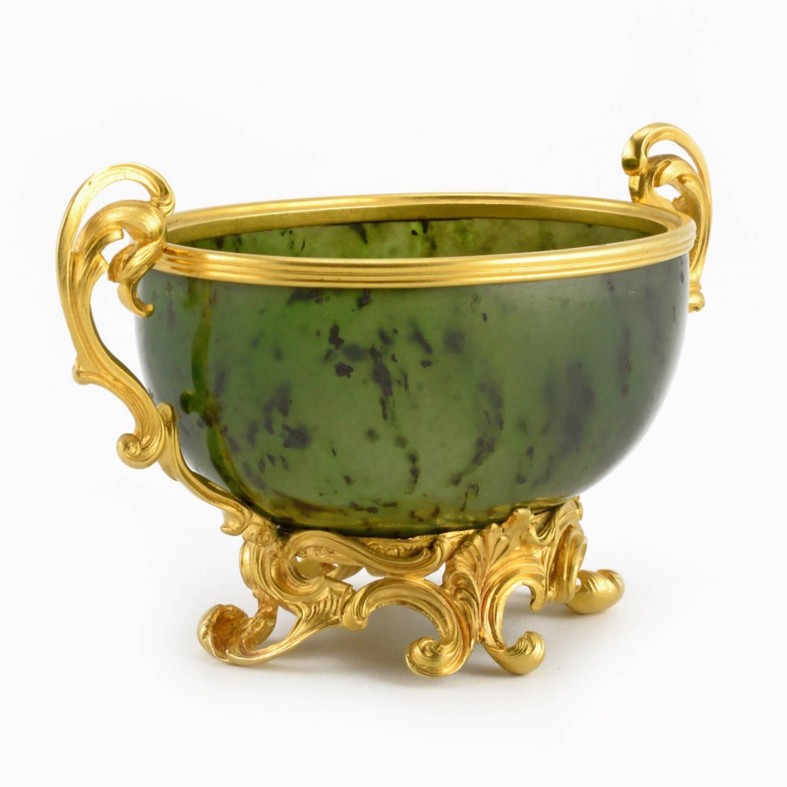 An Imperial and Royal Fabergé gold-mounted carved nephrite bowl, workmaster Michael Perchin, Saint Petersburg, circa 1890, with original Fabergé scratched inventory number 40880. The oval bowl expertly carved from gem-quality nephrite, known as