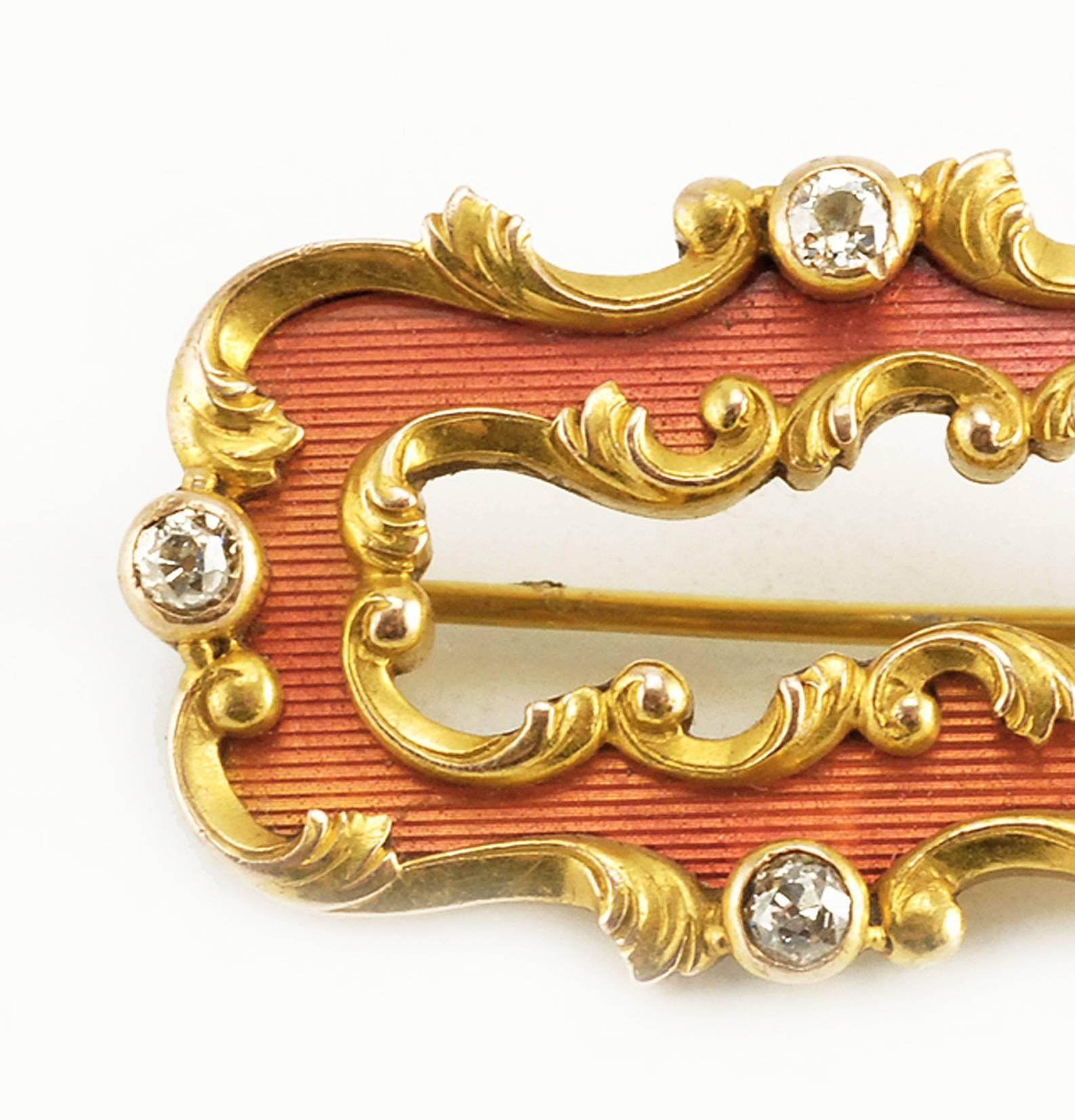 A Fabergé gold-mounted and diamond-set guilloché enamel brooch, workmaster Oscar Pihl (1860-1897), Moscow, circa 1900. Of shaped rectangular outline, the surface enameled translucent salmon-hued peach over engine-turned reeding, within finely