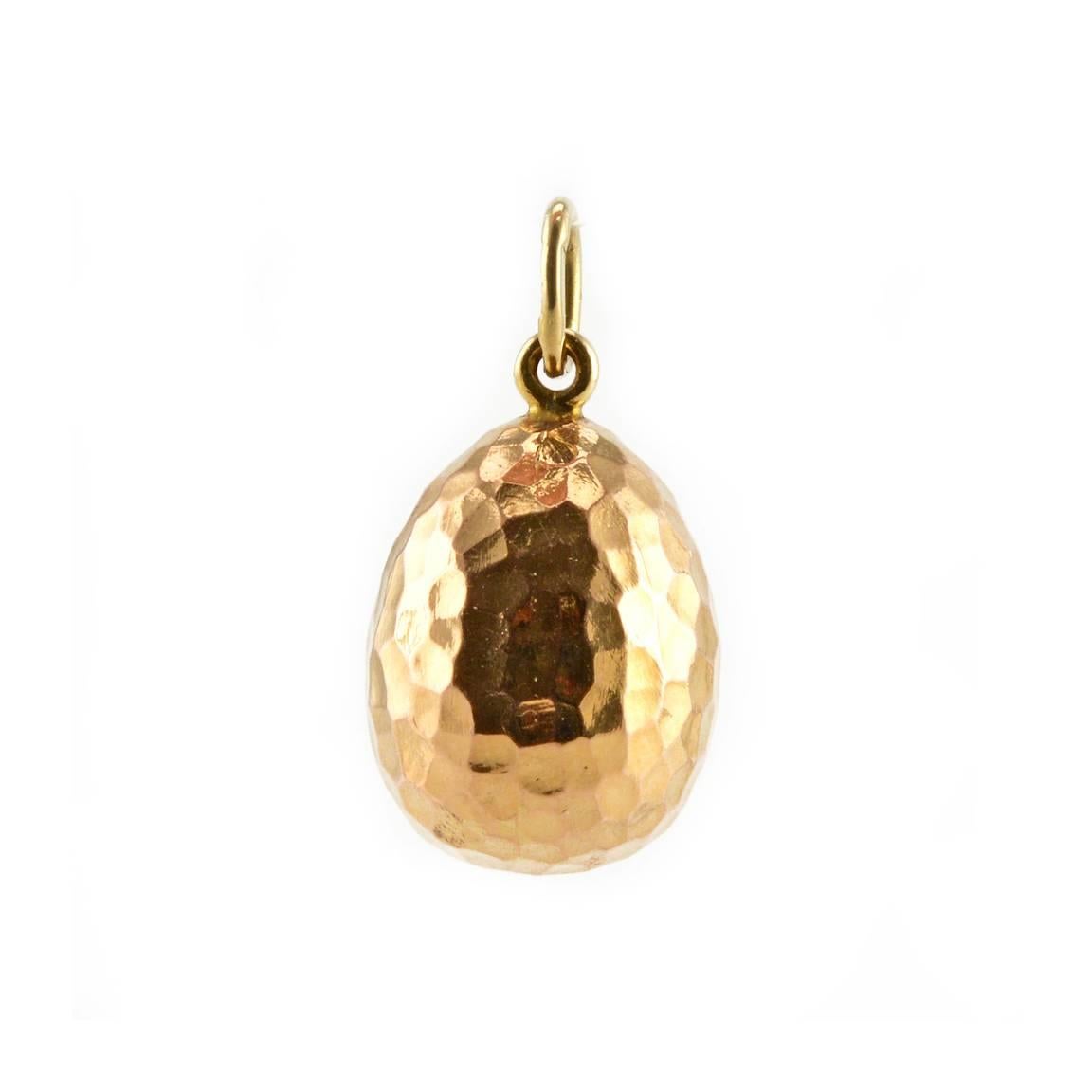 A Fabergé diamond-set gold miniature pendant Easter egg, Saint Petersburg, 1908-1917. The egg of hammered gold, the front with a chased anchor set with rose cut diamonds. Height ¾ in. (1.9 cm).

This design, and versions of it, were popular with