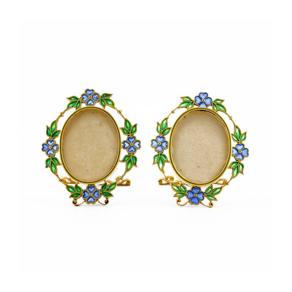 An exquisite pair of Austrian gilded silver and plique-à-jour enamel miniature photograph frames, Georg Adam Scheid, Vienna, circa 1890. The oval frames applied with a border of blue flowers and green foliage in plique-à-jour enamel connected with a
