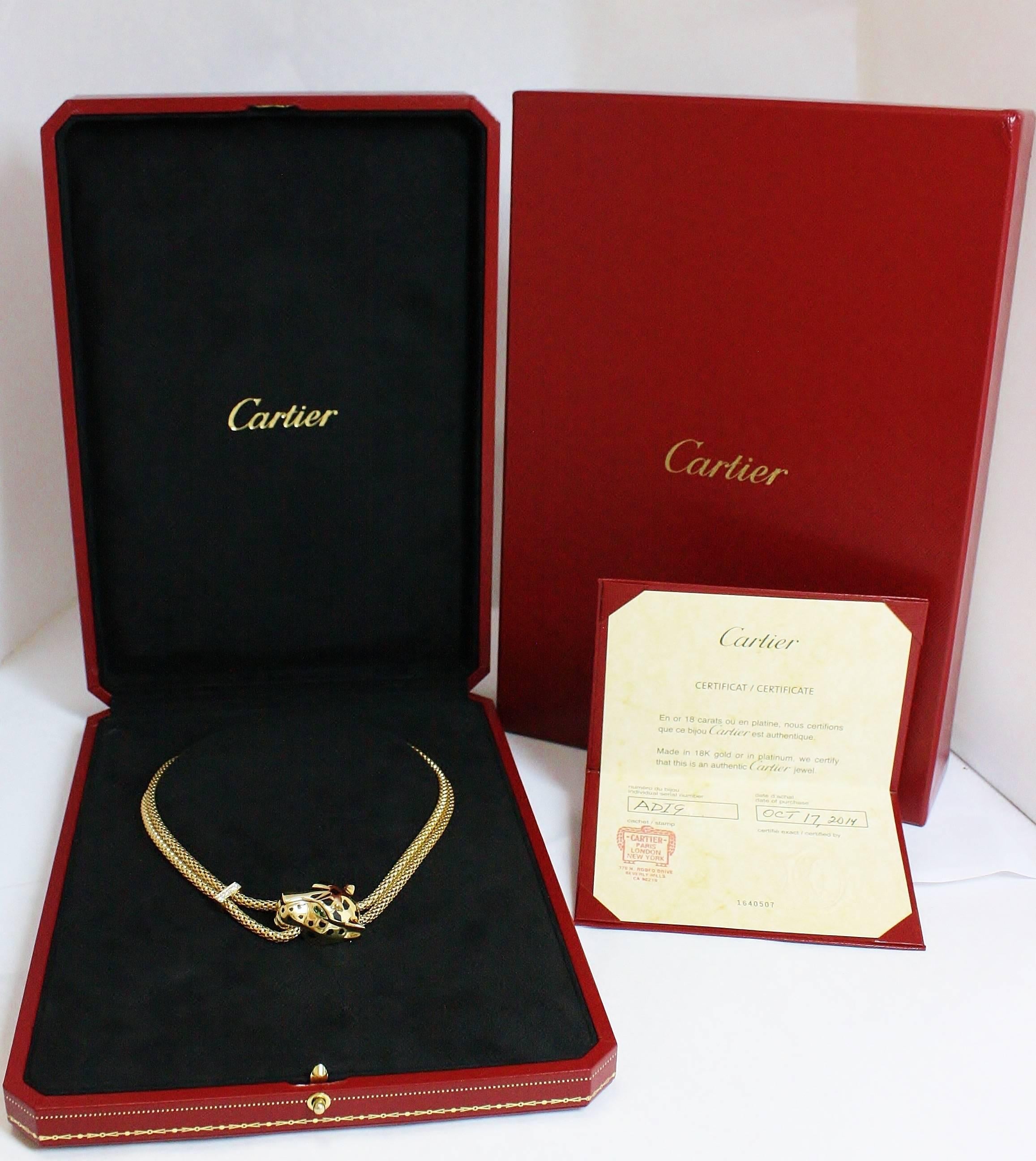 The Panthére De Cartier is a bold contemporary design by Cartier featuring a Panther head clasp connected to an elegant braided chain. The piece stands out as a collar style necklace with the Panther's head and its Tsavorite Garnet Eyes, but can