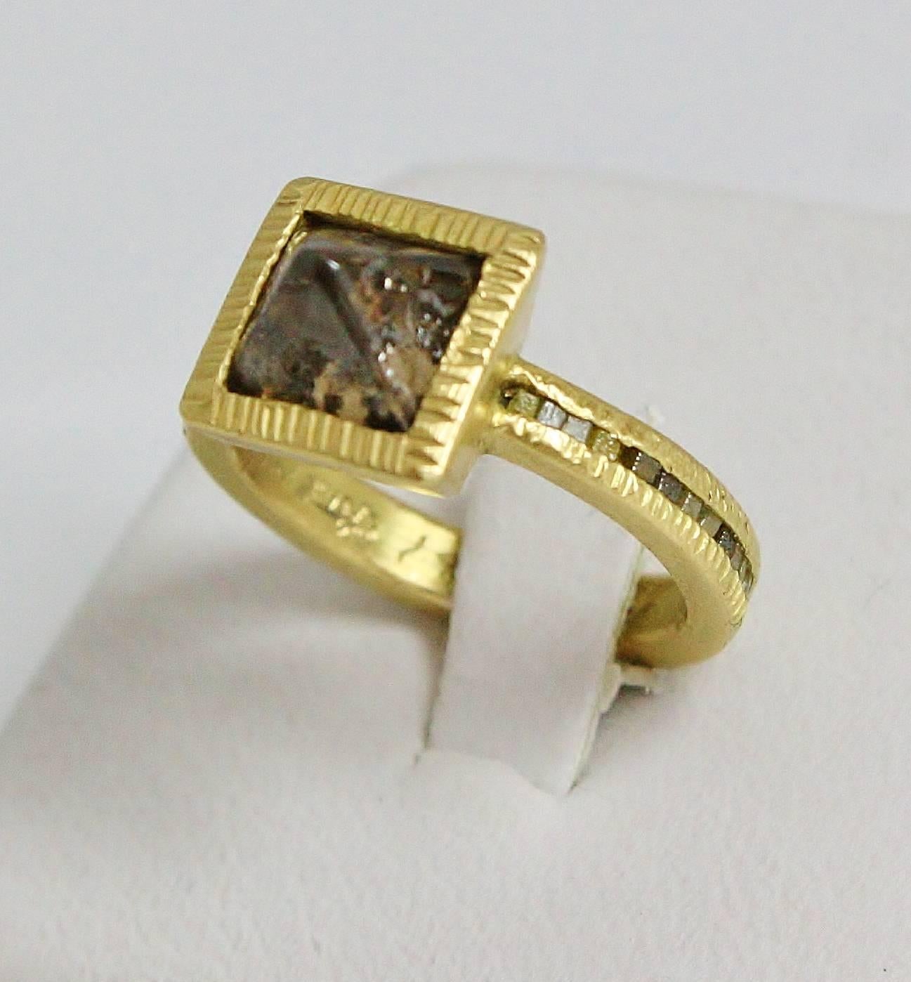 This ring is made of 18kt Yellow Gold with a Raw Octahedron Diamond Center with Raw Diamond Accents along the shank.  The ring weighs 7.45 grams and is a size 5 3/4. It has a 9.9mm square top that is 5.5mm tall with a 3.11mm thick shank. The Center