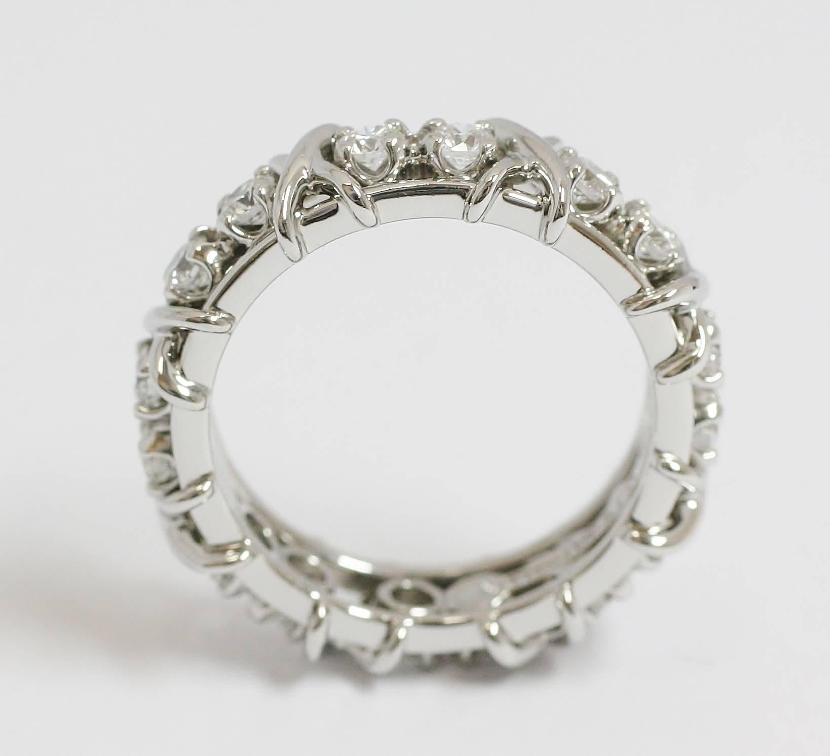 The Tiffany & Co Schlumberger Diamond X band measures 5.4 mm wide with 16 Diamonds for approximately 1.22 ctw and is cast from 950 Platinum. The ring is a size 7.5