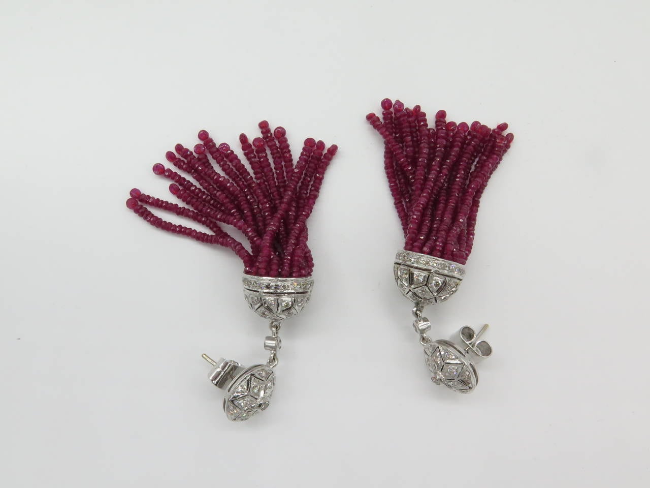 This outstanding 100.72 carats Genuine Burma Rubies bead tassel earring set in 18K white gold forming a cascade, creates a captivating sculptural jewel, with Ice Diamond on top. Wear them to your next event. Total Length:3 inches. totaling white