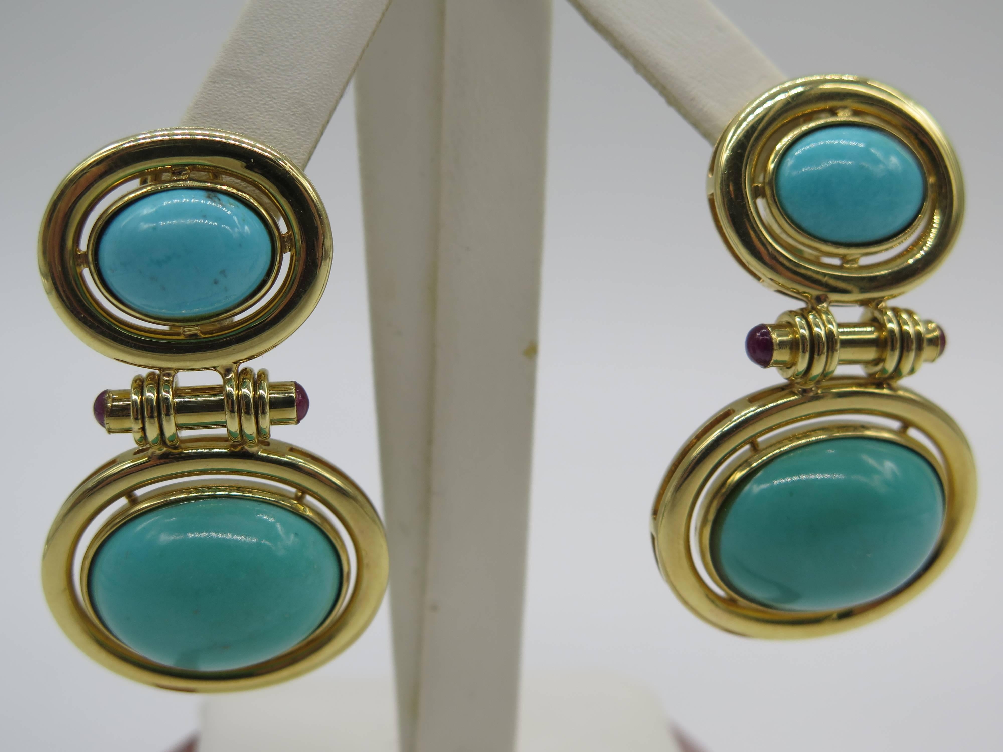 These amazing earrings feature four cabochon turquoise, and four cabochon ruby's, set in 18k yellow gold. Earrings measure approx.1 3/4-inches in length and 1 inch wide.Total weight is 34.0 grams. 