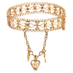 Antique Victorian 18K Yellow Gold Filigree Hinged Bangle with Heart Charms