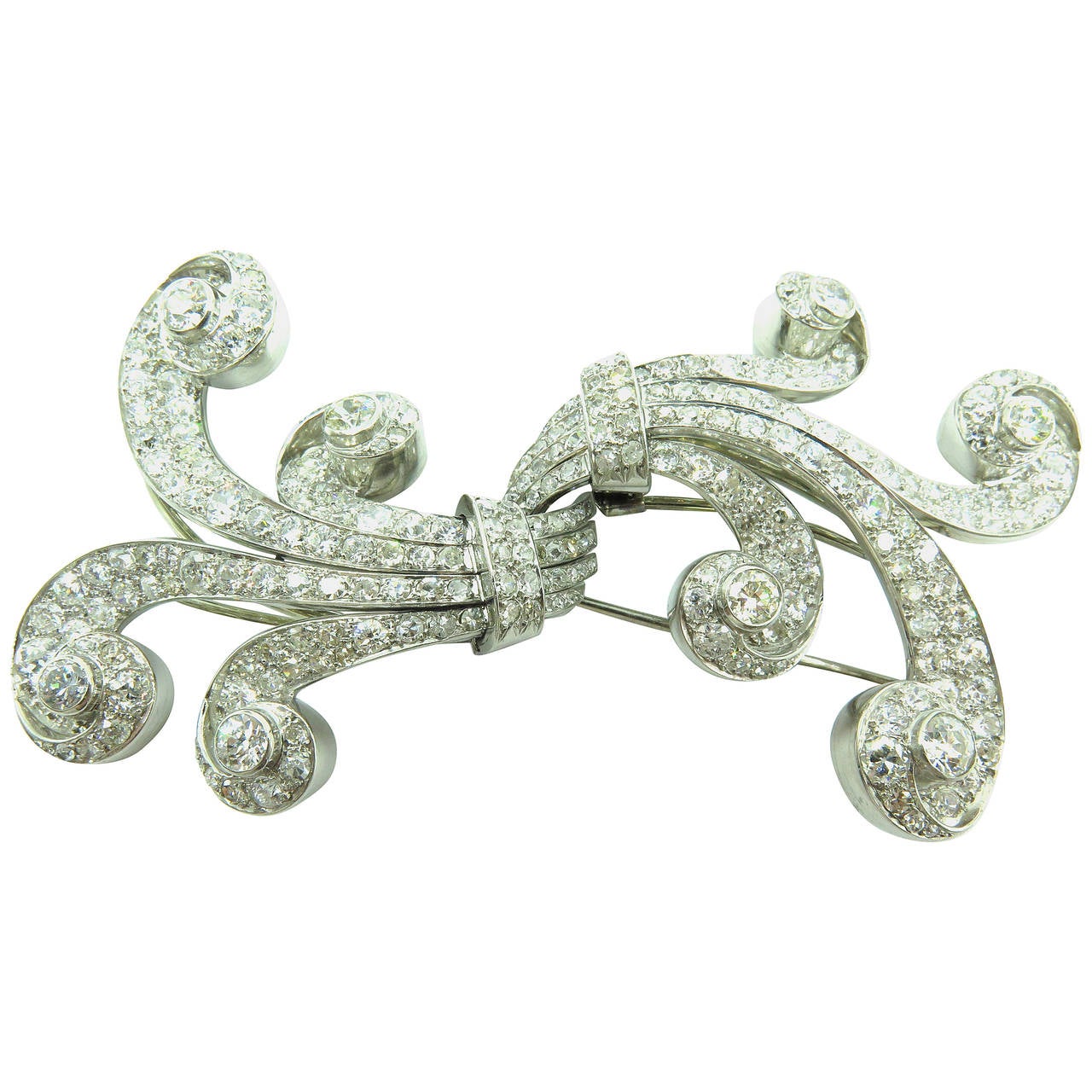 This large gorgeous flowing retro double dress clip can either be worn as 2 separate clips/pins or 1 very large important brooch. I can picture this piece being worn by Katherine Hepburn back in the 40's. There are approximately 13.50ct diamonds. It