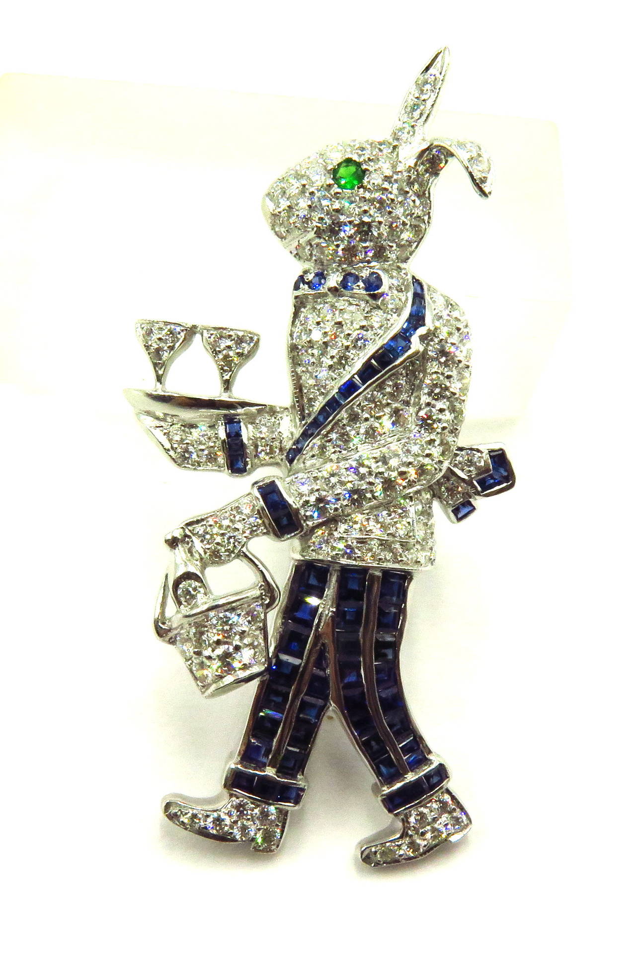 This 18k rabbit pin is the smaller of 2 large pins available. (Other pin also available/listed). They can be bought individually or as a pair. This tall bow tied rabbit holding his wine bottle inside the basket in one hand and a refreshing pair of