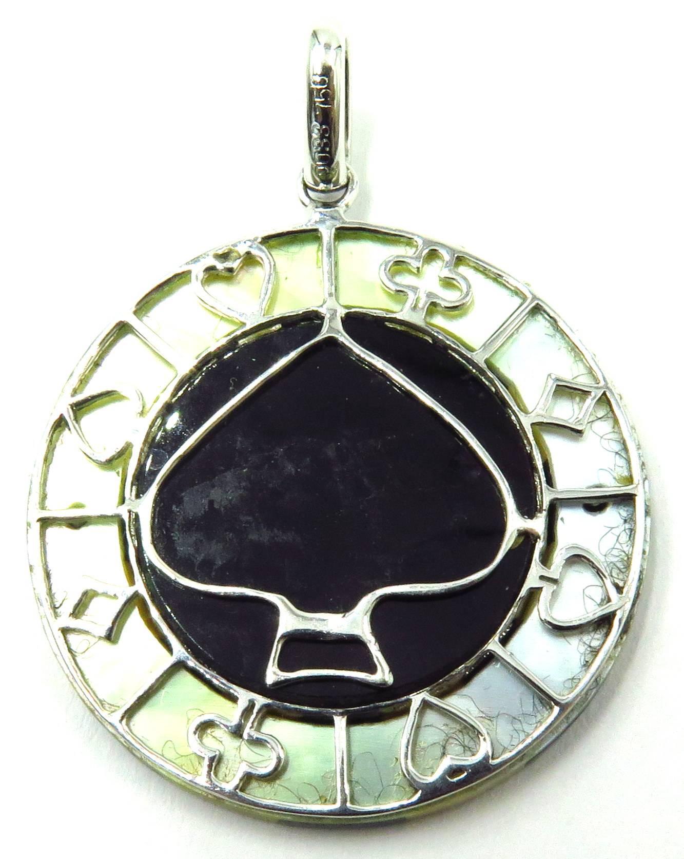 This lucky charm is just what you need whether your playing the tables, playing with love, or just playing in your day to day life! This beautifully made 18k white gold inlaid onyx, coral, mother of pearl and diamond casino looking poker chip is