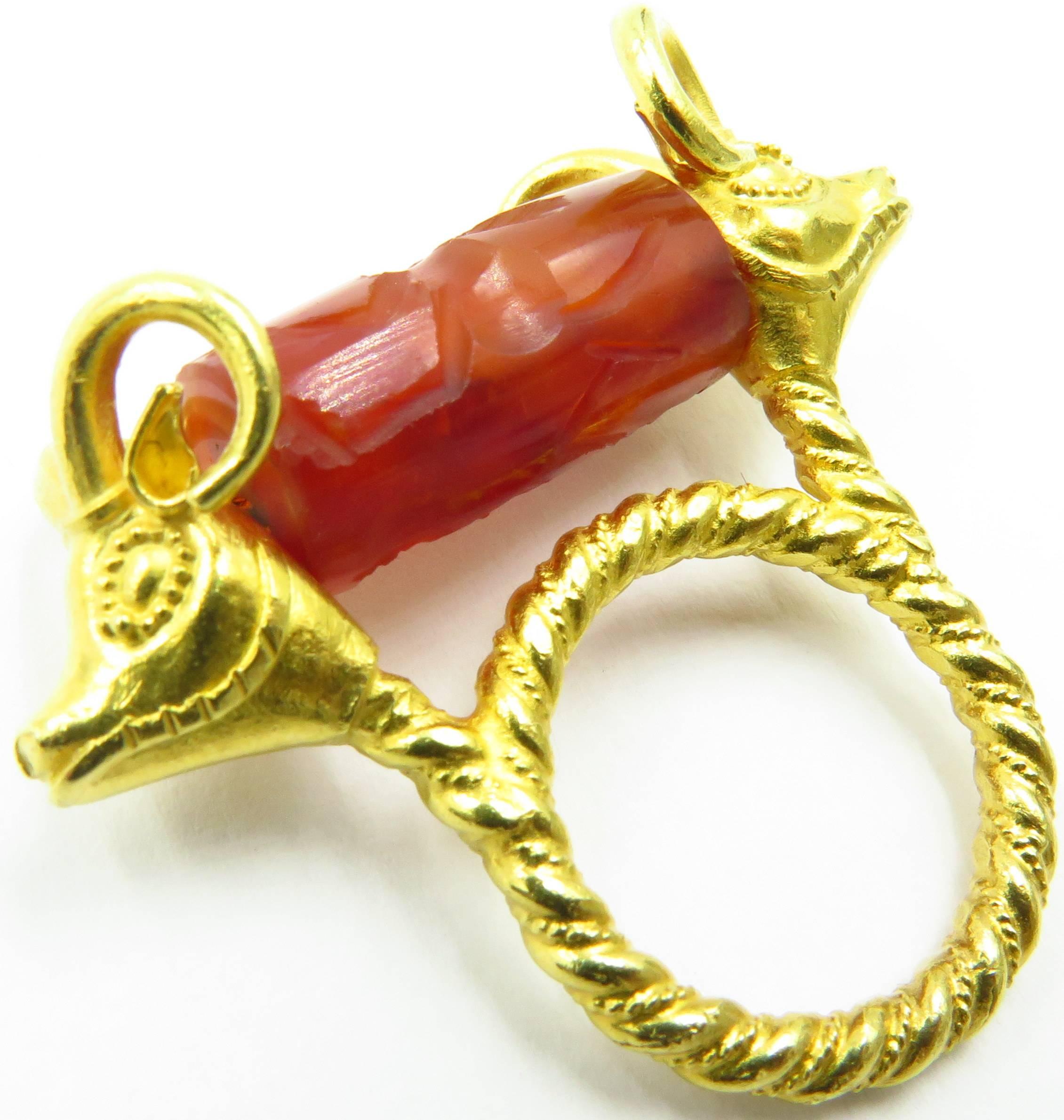 This marvelous ring is perfect in so many ways. It's high 22k gold, The carved carnelian stone that spins (I love this to give me something to do when I'm feeling nervous). The Etruscan work on the Rams! And it's very comfortable to wear. It's just