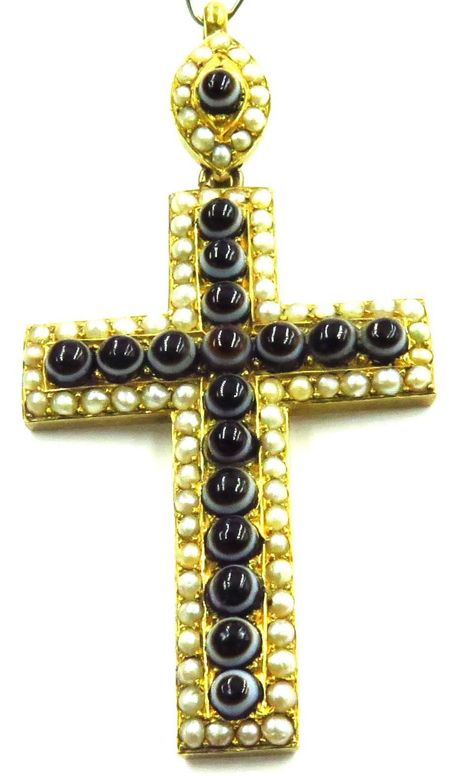 This incredible antique cross is perfection. It has an amazing patina throughout the natural pearls that surround the 18 mini banded agate cabochons. It has the original bale that can on or to a chain of your choice. 
This cross is 2 1/2 inches