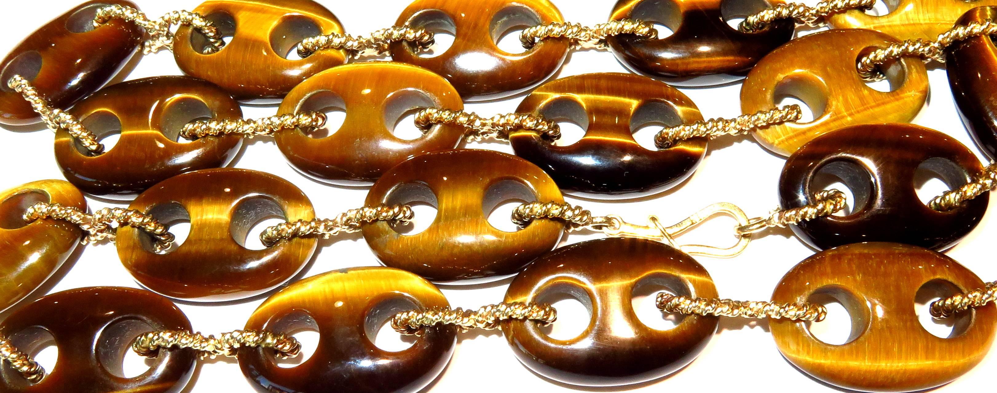 This dramatic tiger eye necklace is so versatile, you will want to wear it every day. The sheen of the tiger eye is hypnotic. Each link is connected by a twisted 14k gold figure 8 design with a fold over mechanism for a safety to secure the lock.