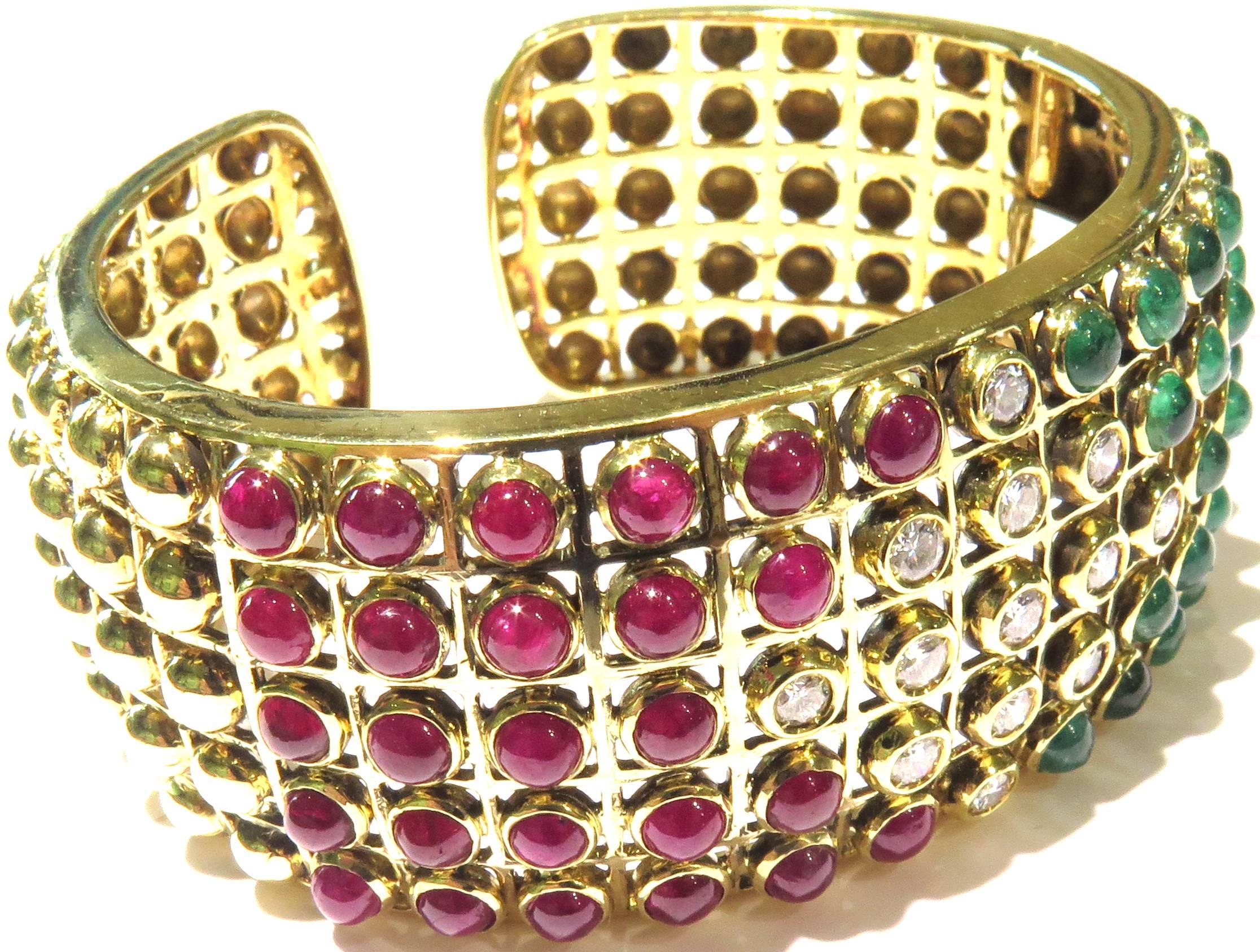 Very well made 18k bezel set diamonds, rubies, and emeralds wide hinged bangle bracelet. So easy to put on and take off.  Very comfortable on. This well made bracelet can be dressed up or down.
This bracelet weighs 74.6 grams
This bracelet is 1