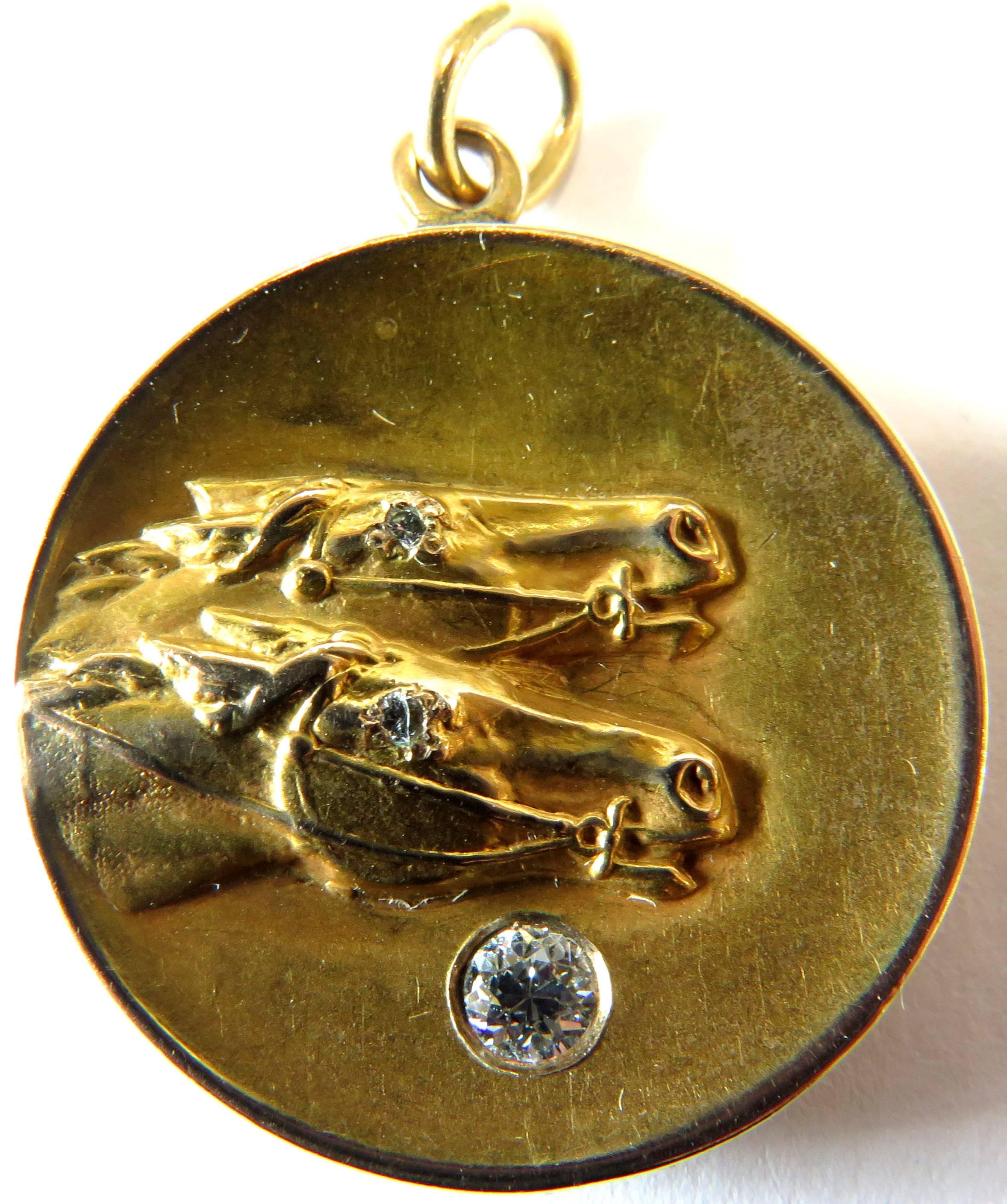This wonderful art deco locket has the most realistic horse head form. This locket has a very rich patina. There are 2 places for your photographic memories. Each of the horses has a diamond for they eye and one at the bottom of of locket. The back