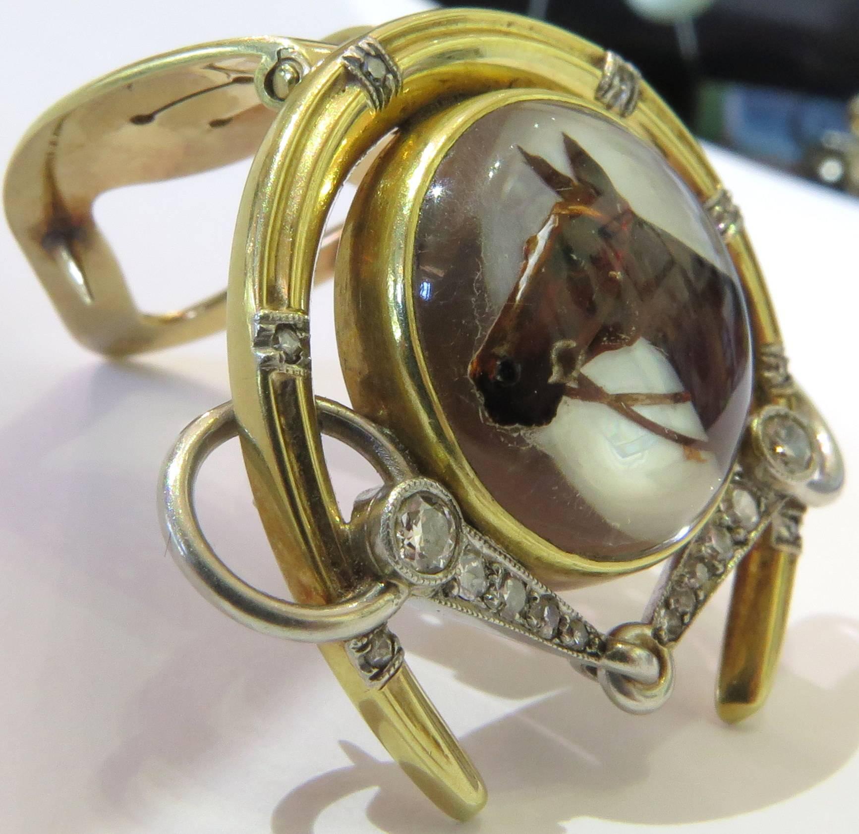 J.E. Caldwell is known for their high quality jewelry. This gold and platinum clip/pin is no exception. The reverse crystal horse head is surrounded by a horseshoe and diamond encrusted horse bit.This exquisite clip can easily be worn by a man or
