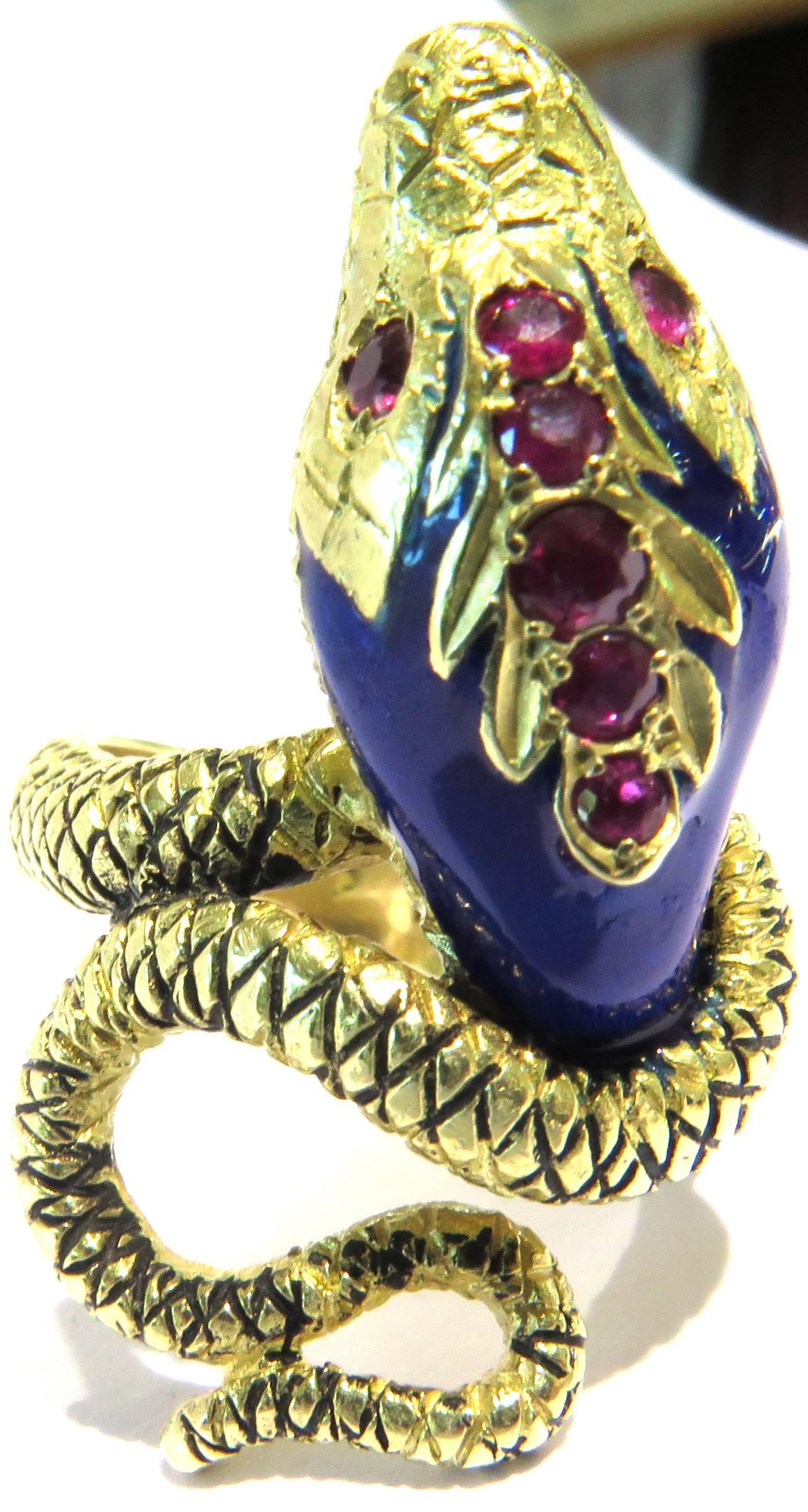 This wonderful 18k snake ring has such comfortably fitting curve around the finger. I love wearing it on my index finger, but it looks great on any finger! This ring is signed (see images 6 and 8) But I am not familiar with the designer. 
This ring