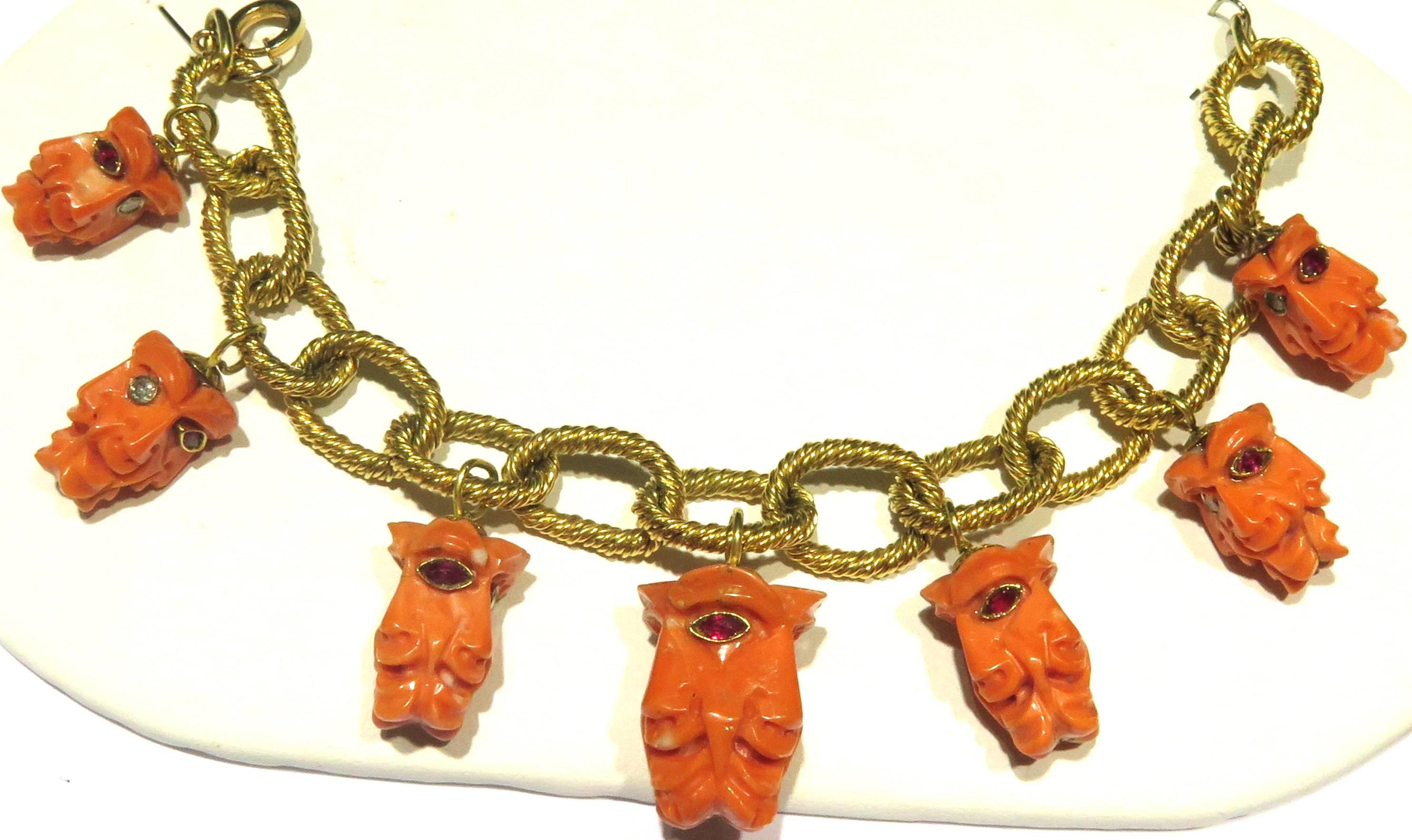 This amazing bracelet is just incredibly unique. First the bracelet is made of 18k large heavy rope motif links. Then each of the 7 carved coral charms has been carved in a way that it has 4 faces. Each side of its 4 faces has 1 bezel set ruby & 1