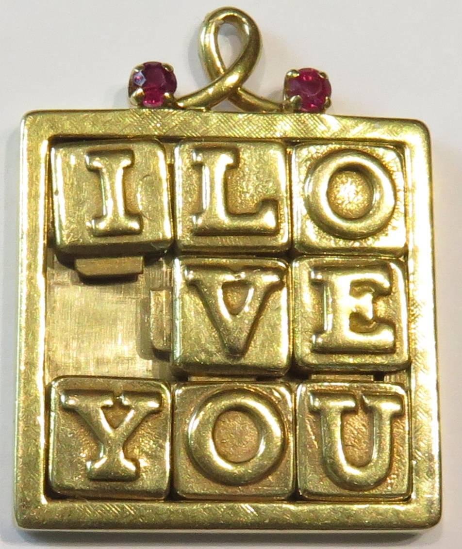 In my opinion, this is Henry Dankner's most incredible charm. Each letter moves exactly like those classic puzzles I used to play with. This special charm/pendant is accented with 2 prong set rubies.
This charm measures 1 1/4 inch high by 1 inch