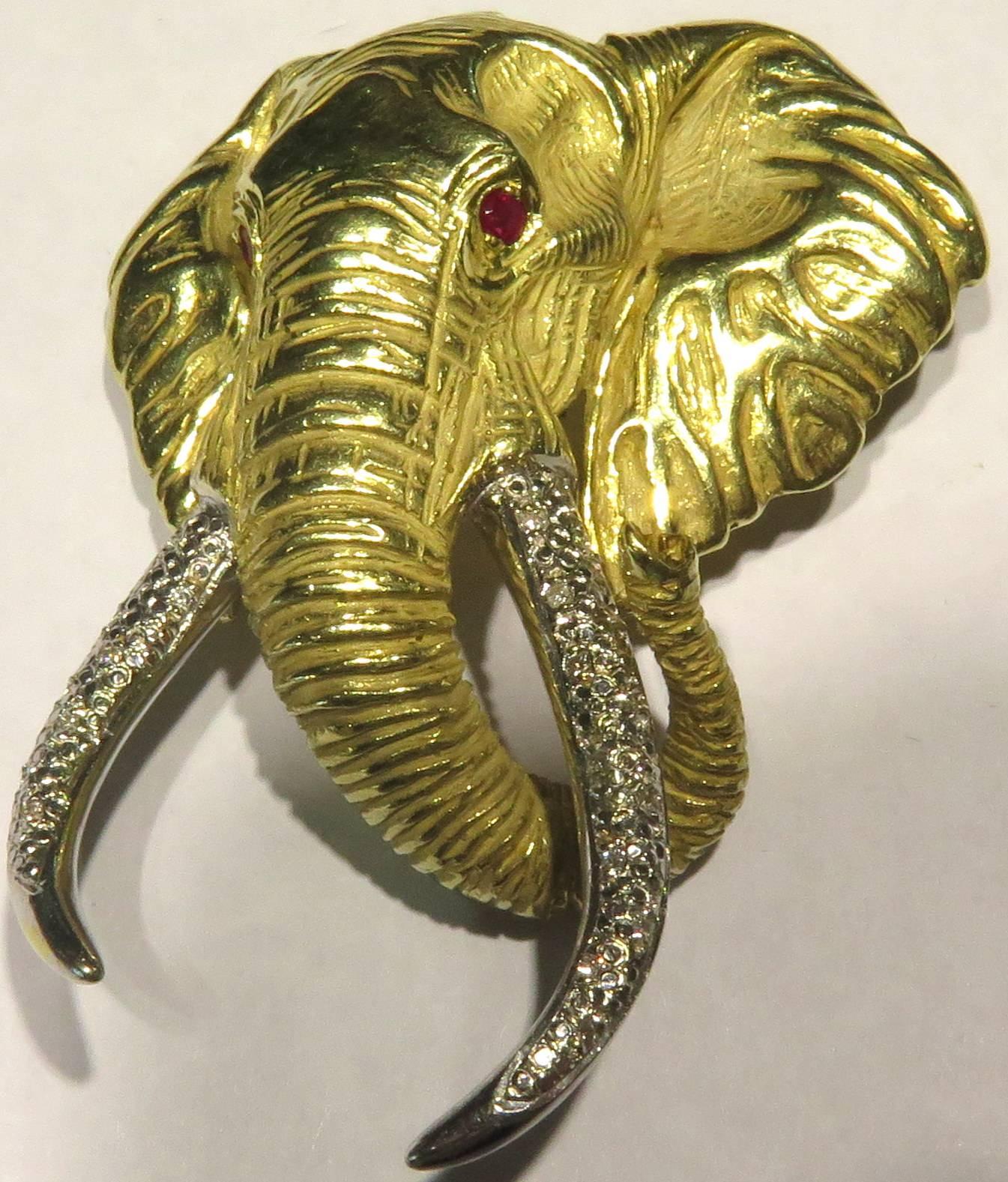 This incredible elephant pin / pendant is a very impressive size. It is signed JOAO and another mark with the 14ct mark that I can't make out *see image 5. The tusks are in white gold with pave' diamonds and the eyes each contain a ruby.
This