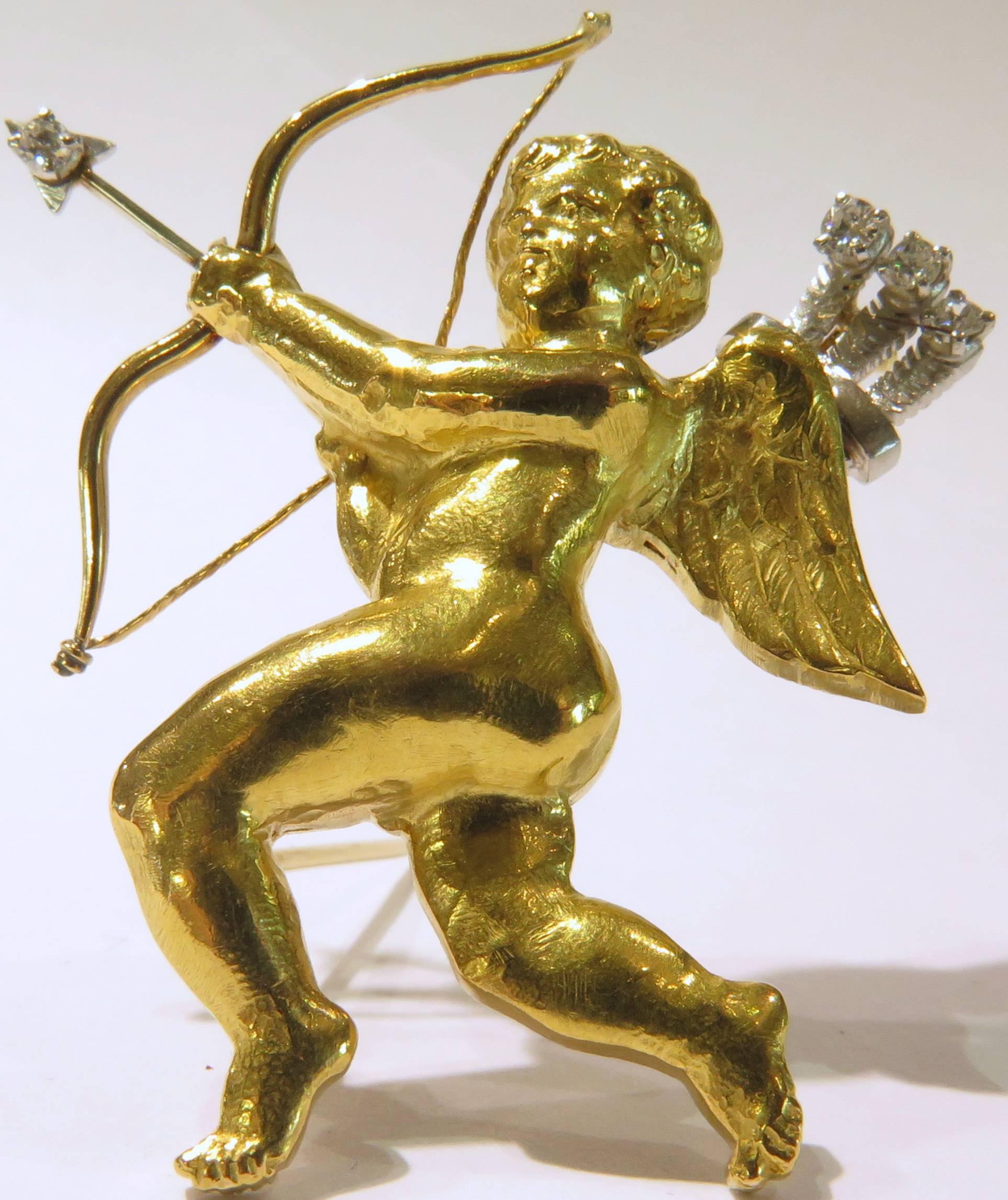 This Mellerio pin is set in 18k yellow gold with white gold accents on his diamond arrows. He is everything a cherub should be,with his rubenesque physique to his angel wings. This pin is sure to win her heart!
This pin weighs  12.3 grams
This pin